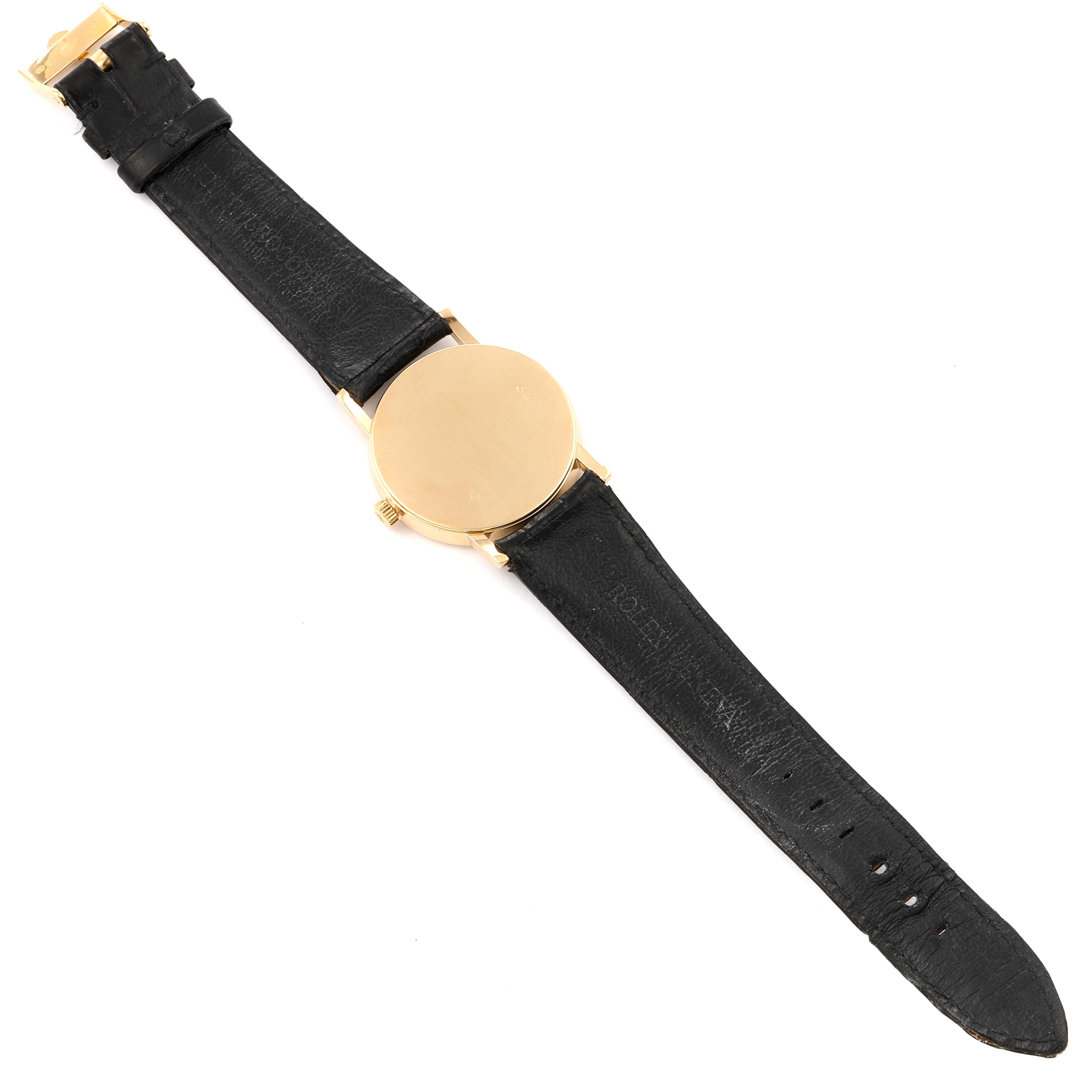 The image shows the back view of a Rolex Cellini 5115 Men's Yellow Gold Silver Dial 5115 Men's Yellow Gold Silver Dial watch, revealing the black leather strap and gold case back.