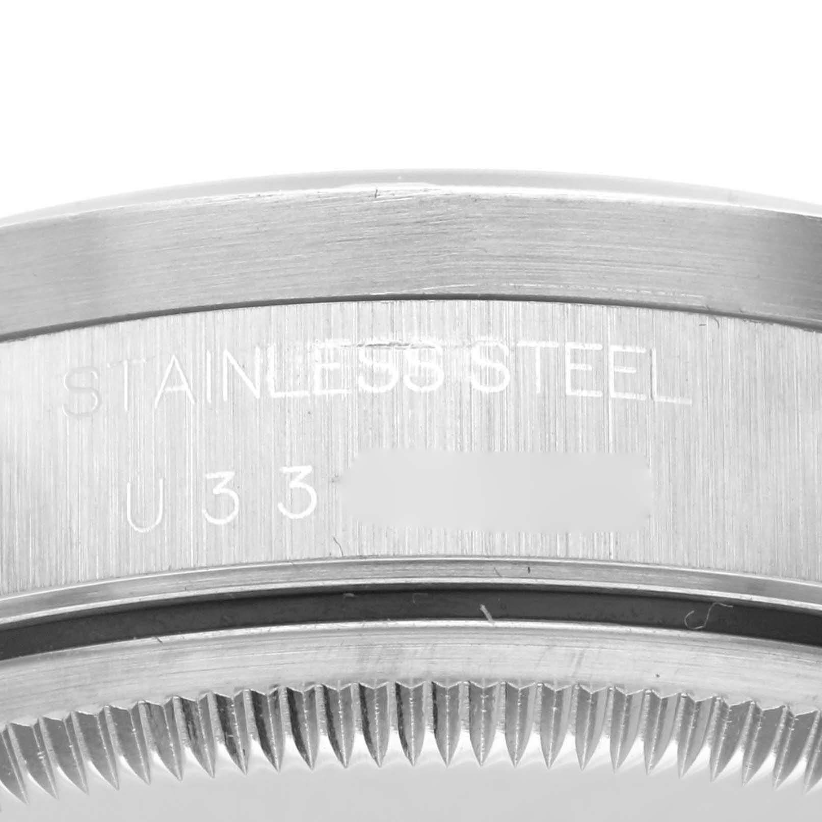 This image shows a close-up of the stainless steel case back and part of the fluted bezel of a Rolex Date 15210 Men
s Stainless Steel Silver Dial 15210 Men
s Stainless Steel Silver Dial model.