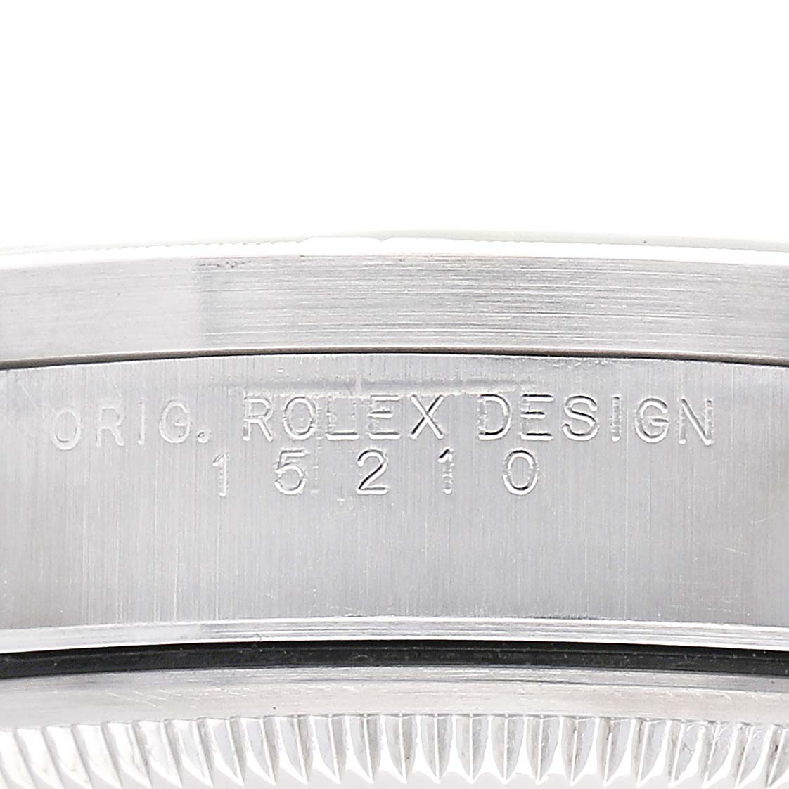 The image shows a side view of the Rolex Date 15210 Men's Stainless Steel White Dial watch, focusing on the engraved serial and model numbers on the case.