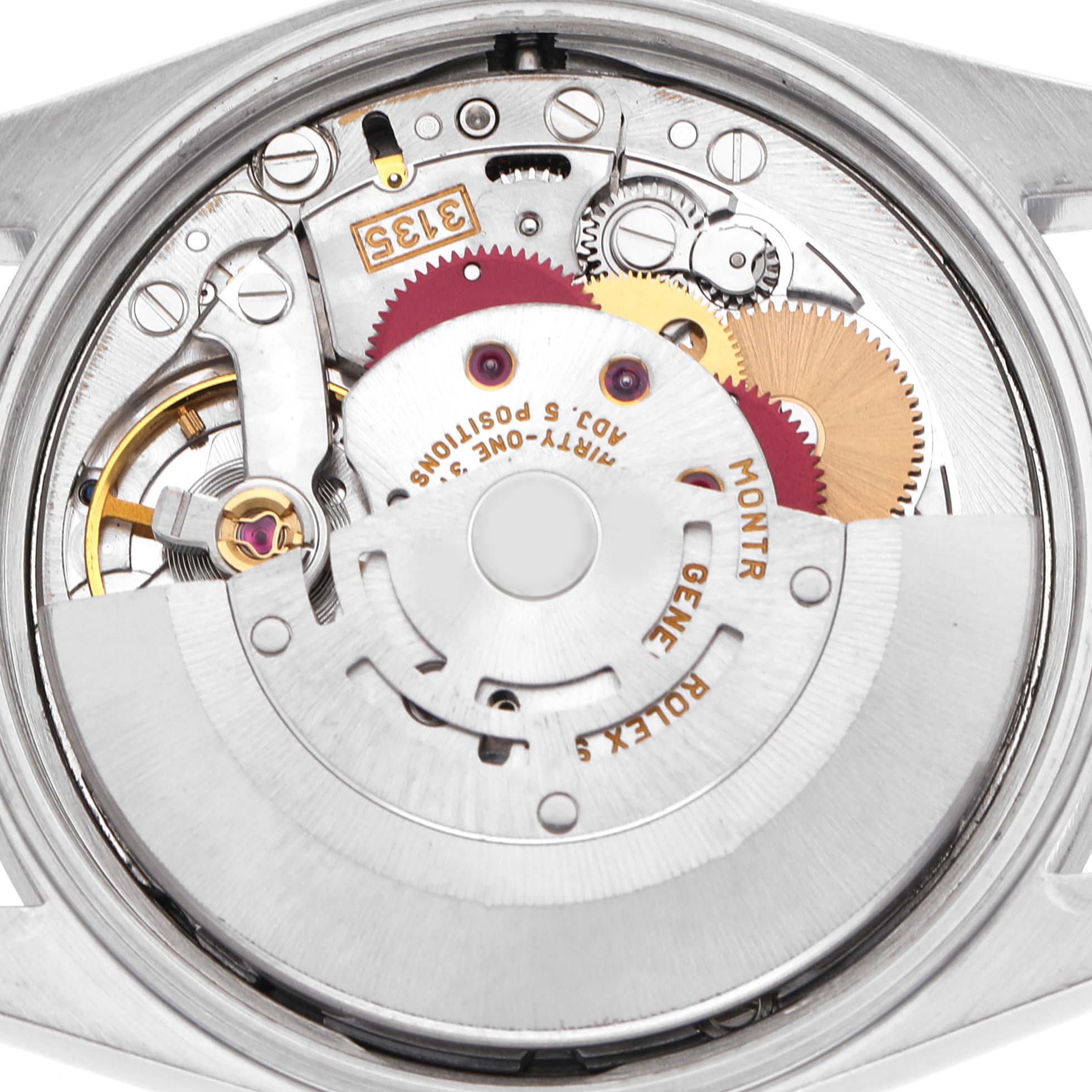 The image shows the movement of a Rolex Date 15210 Men's Stainless Steel White Dial model from the back, highlighting gears and mechanical components.