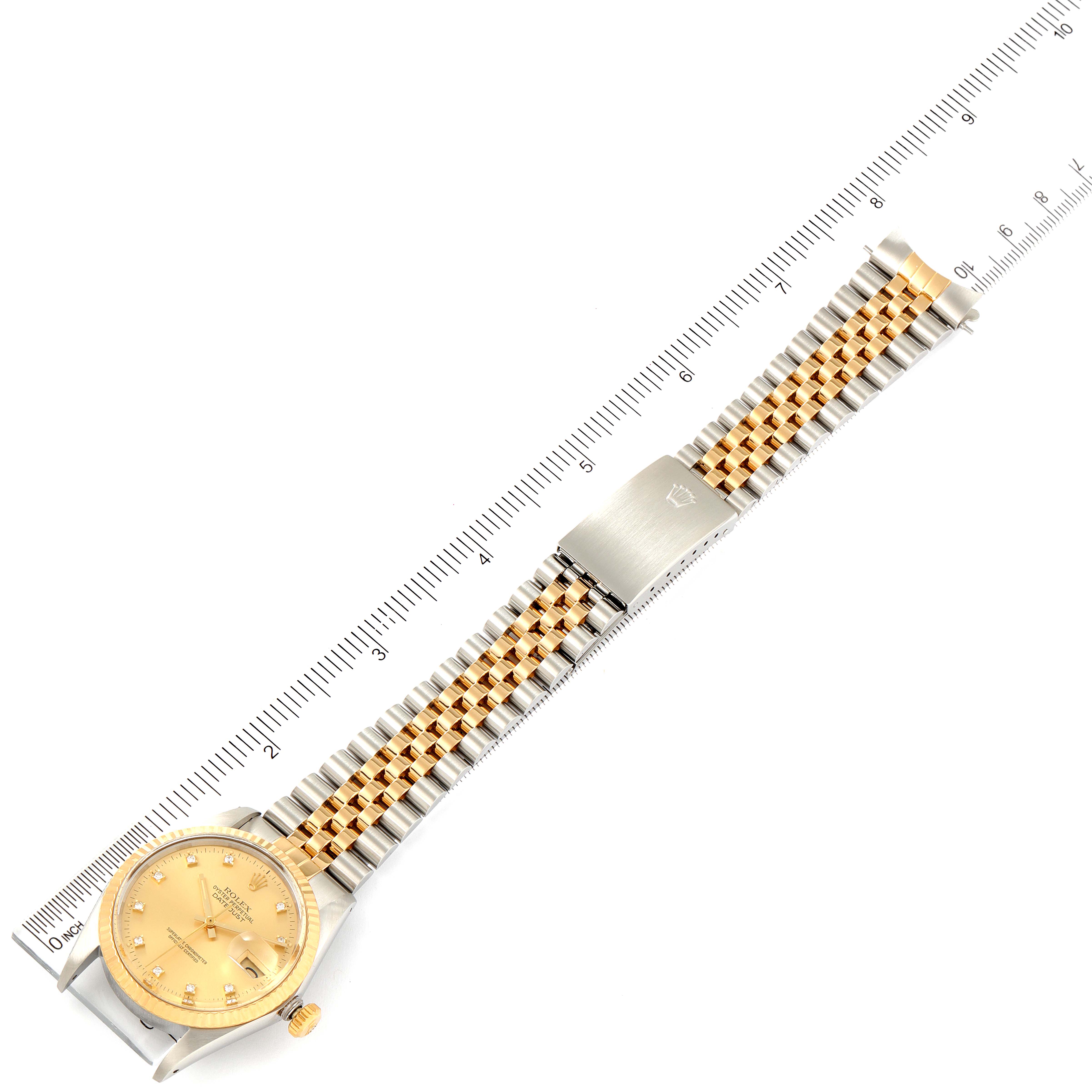 The image shows a top-down view of a Rolex Vintage Collection 16013 Men's Steel and Gold (two tone) Champagne Dial 16013 Men's Steel and Gold (two tone) Champagne Dial watch with its band and clasp extended along a ruler.