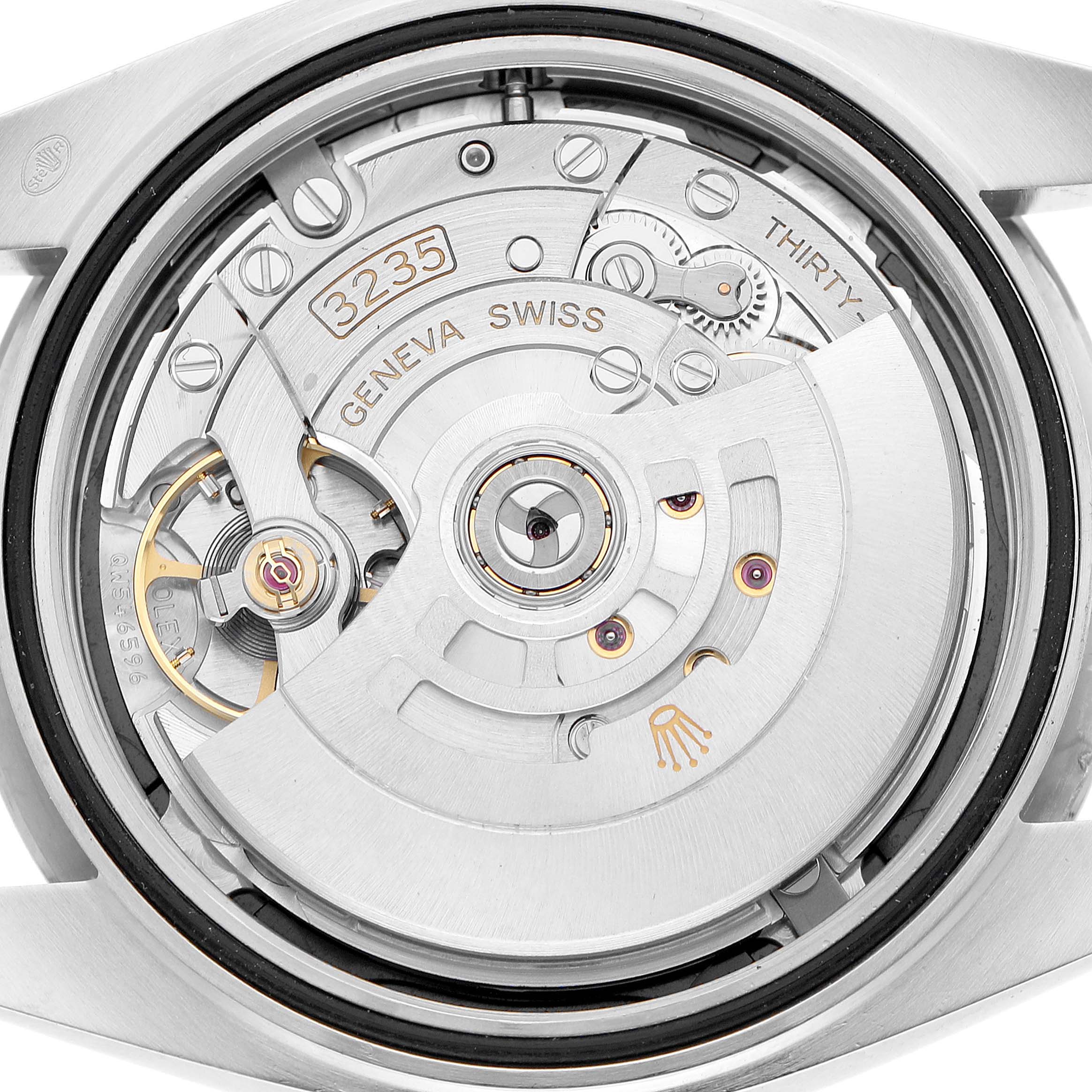 The image shows the back view of a Rolex Datejust 41 126334 Men's Steel and Gold (two tone) Grey Dial, focusing on the movement and internal mechanics.