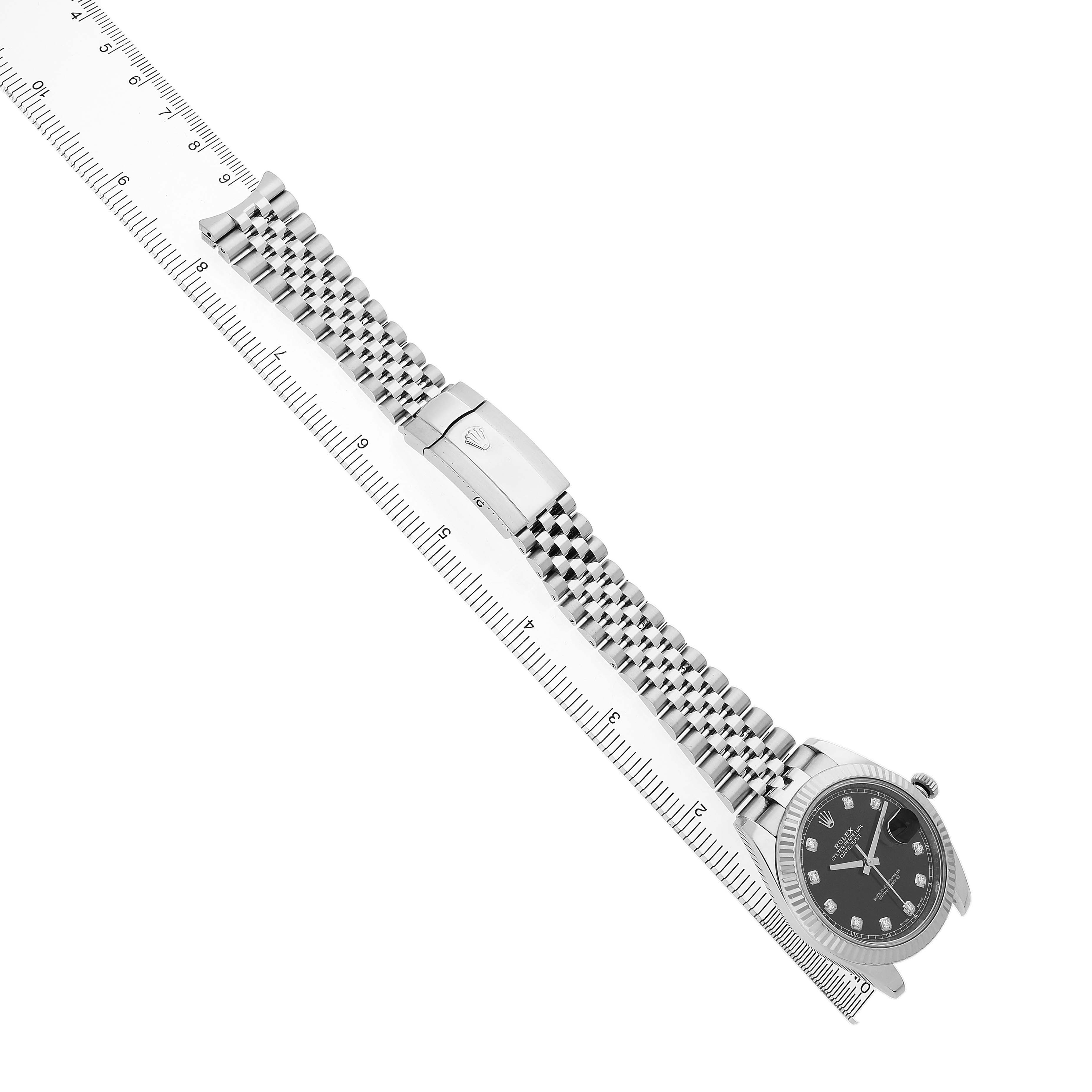 The Rolex Datejust 41 126334 Men's Steel and Gold (two tone) Grey Dial watch is shown at an angled side view, displaying the bracelet, clasp, and dial alongside a ruler.