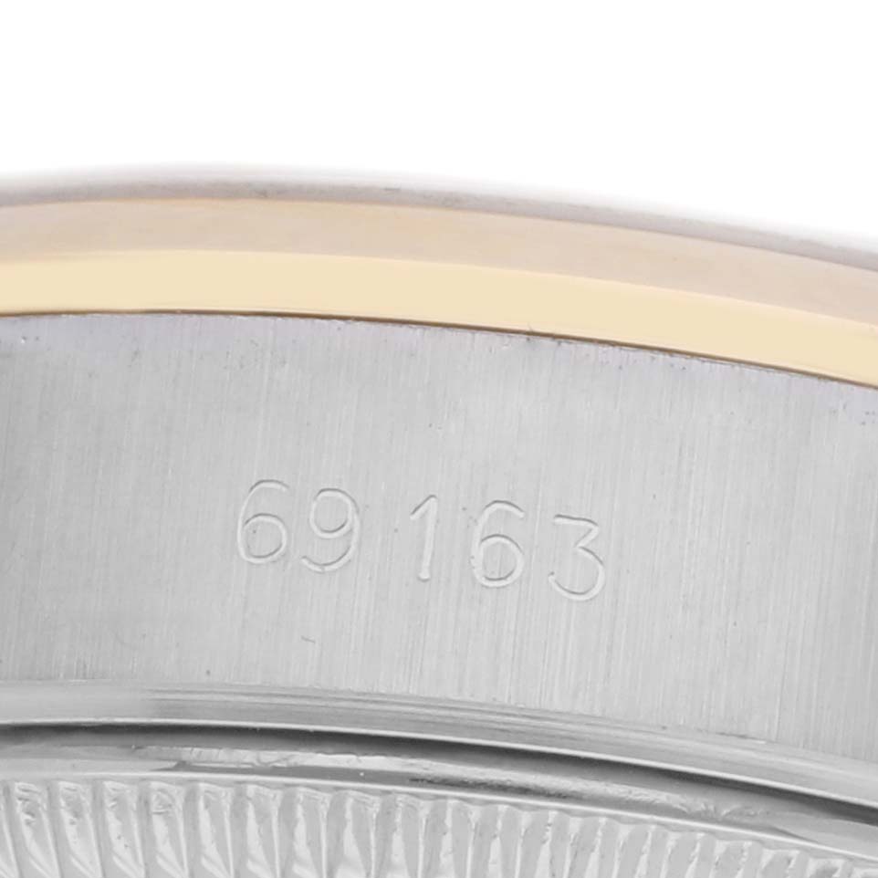 The image shows a close-up of the case edge and serial number of the Rolex Datejust 69163 Women's Steel and Gold (two tone) Champagne Dial 69163 Women's Steel and Gold (two tone) Champagne Dial model.
