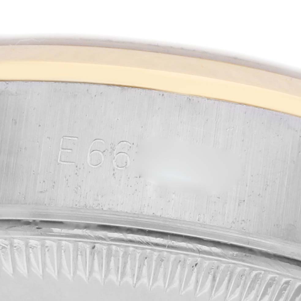 The image shows a close-up of the side of the Rolex Datejust 69163 Women's Steel and Gold (two tone) Champagne Dial 69163 Women's Steel and Gold (two tone) Champagne Dial watch, focusing on the edge of the bezel and case with engraved details.