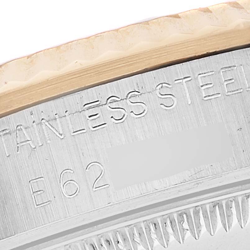 This image shows a close-up of the side of a Rolex Mid-Size 68273 Women's Steel and Gold (two tone) White Dial 68273 Women's Steel and Gold (two tone) White Dial model watch, focusing on the bezel and stainless steel engraving.