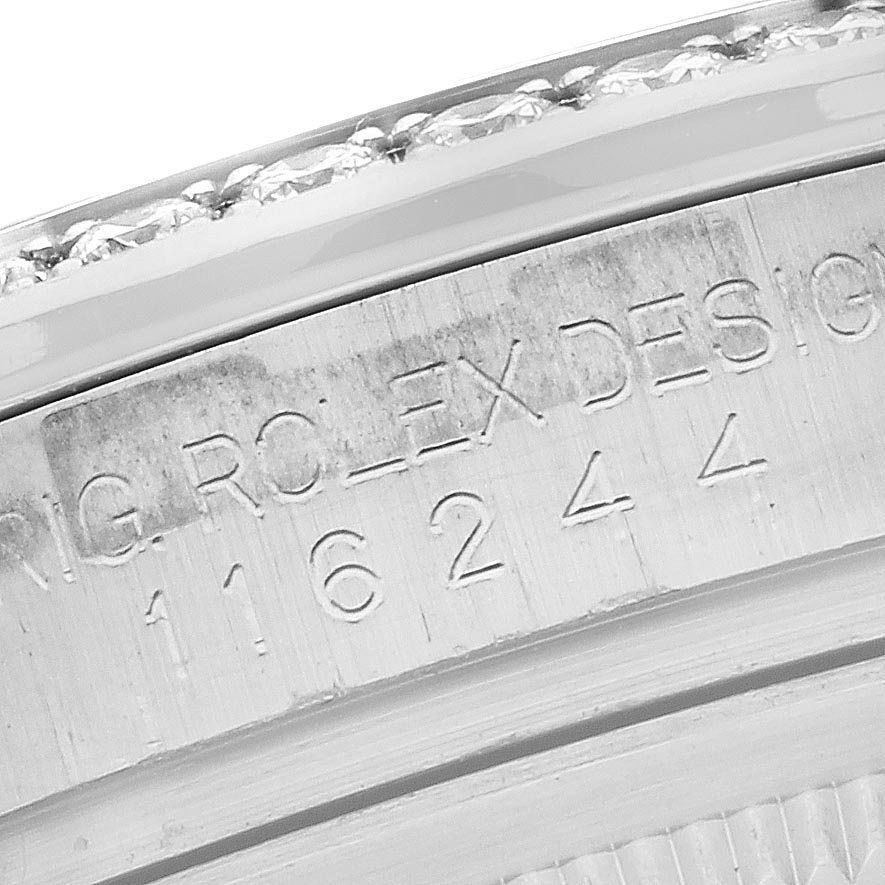 The image shows a close-up of the engraving on the case of a Rolex Datejust 116244 Men's Stainless Steel Mother of Pearl Dial 116244 Men's Stainless Steel Mother of Pearl Dial watch.