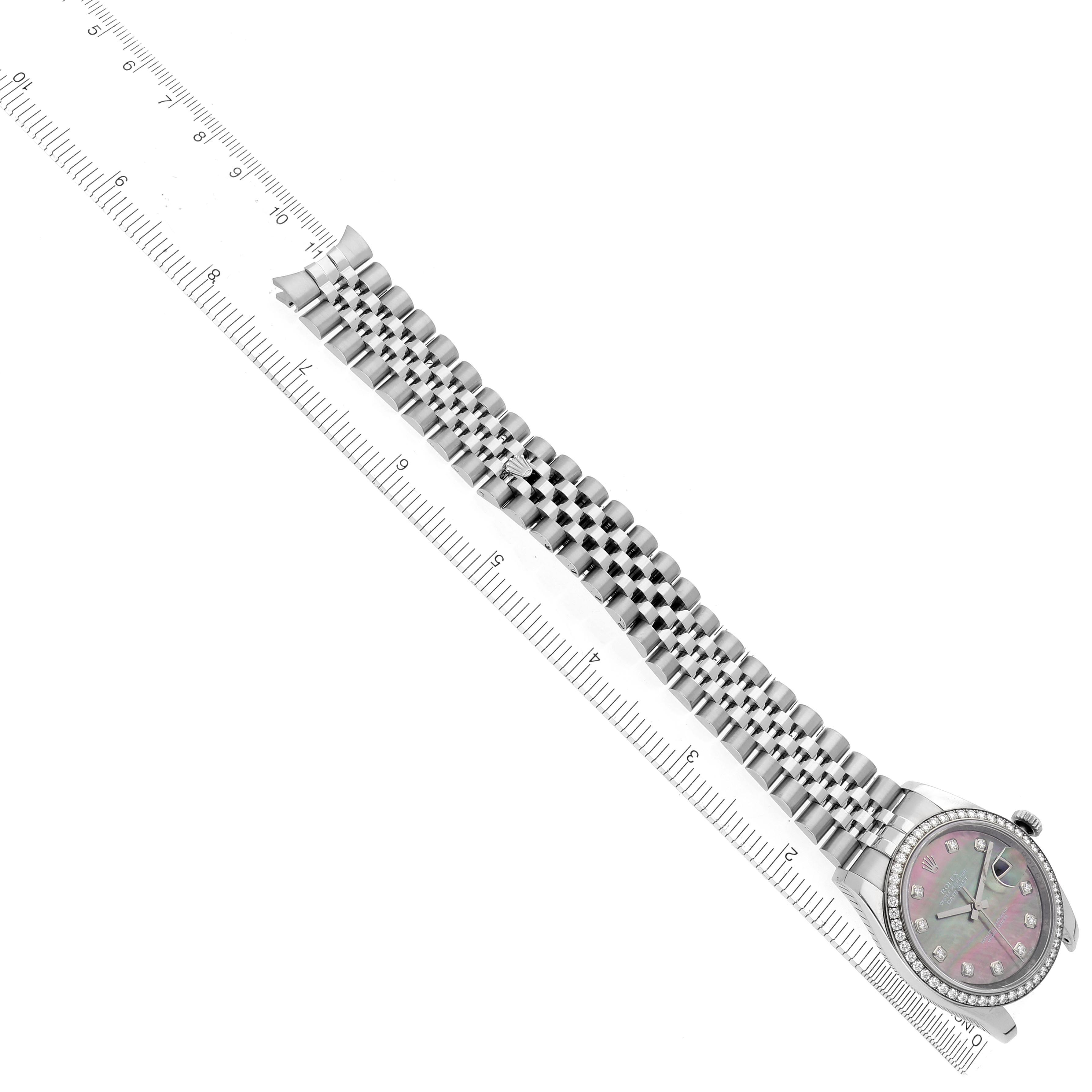 The Rolex Datejust 116244 Men's Stainless Steel Mother of Pearl Dial 116244 Men's Stainless Steel Mother of Pearl Dial watch is shown from a top angle, displaying the bracelet, dial, and bezel alongside a ruler.