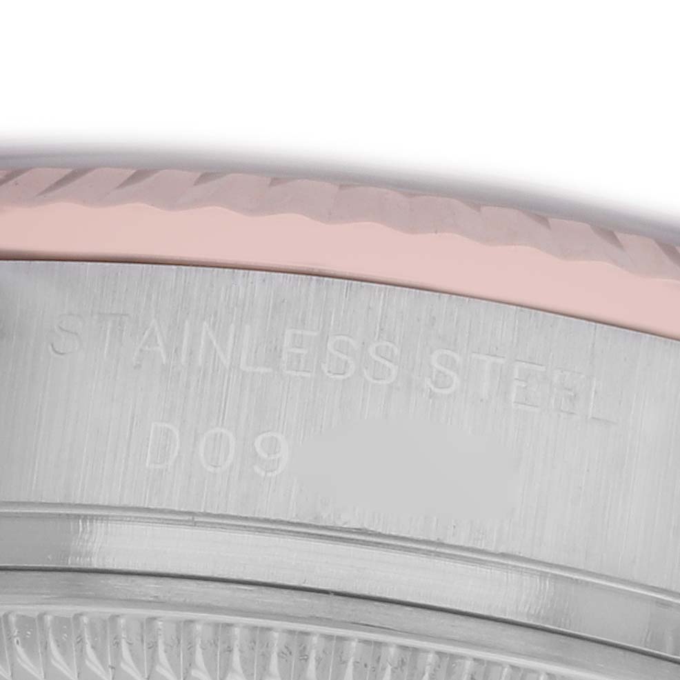 The image shows a close-up of a Rolex Datejust 179171 Women's Steel and Gold (two tone) White Dial 179171 Women's Steel and Gold (two tone) White Dial's side, highlighting its stainless steel case with engraved lettering.