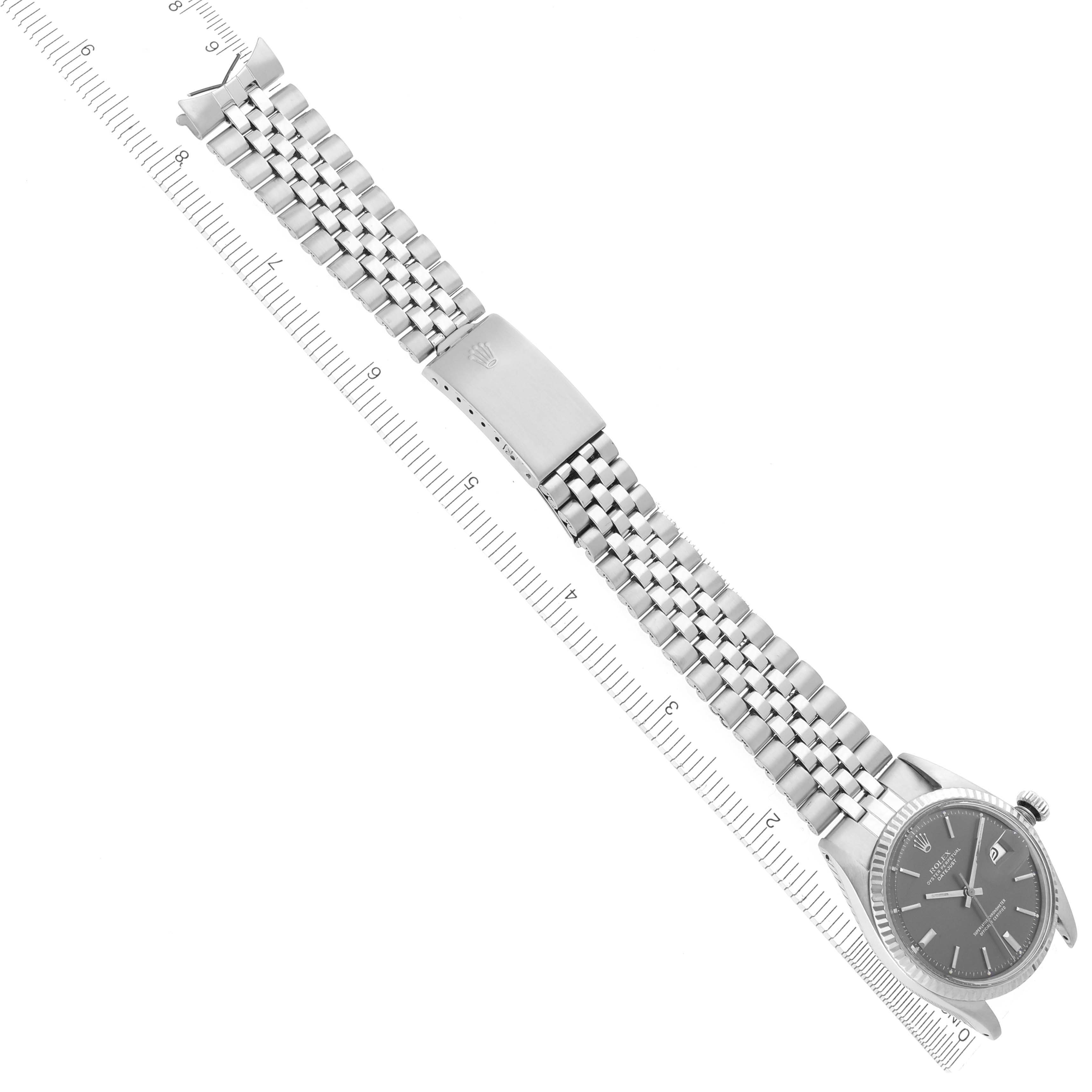 The image shows a Rolex Datejust 1601 Men's Stainless Steel Grey Dial 1601 Men's Stainless Steel Grey Dial watch laid flat, highlighting its bracelet, clasp, and face at an angled side view.