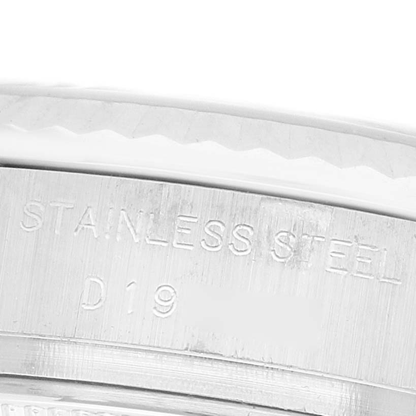 The image shows a close-up of the stainless steel casing and engravings on the Rolex Datejust 179174 Women's Stainless Steel Pink Dial watch.