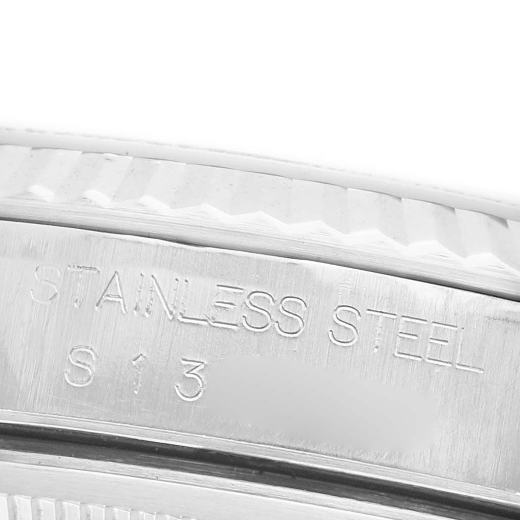 The image shows a close-up of the Rolex Datejust 16234 Men's Steel and Gold (two tone) Silver Dial's stainless steel case with engraved markings.