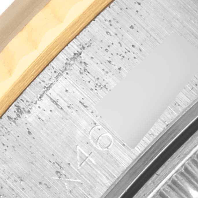 This close-up image shows the edge of a Rolex Datejust 69173 Women's Steel and Gold (two tone) Black Dial 69173 Women's Steel and Gold (two tone) Black Dial bezel and part of the case from a side angle.