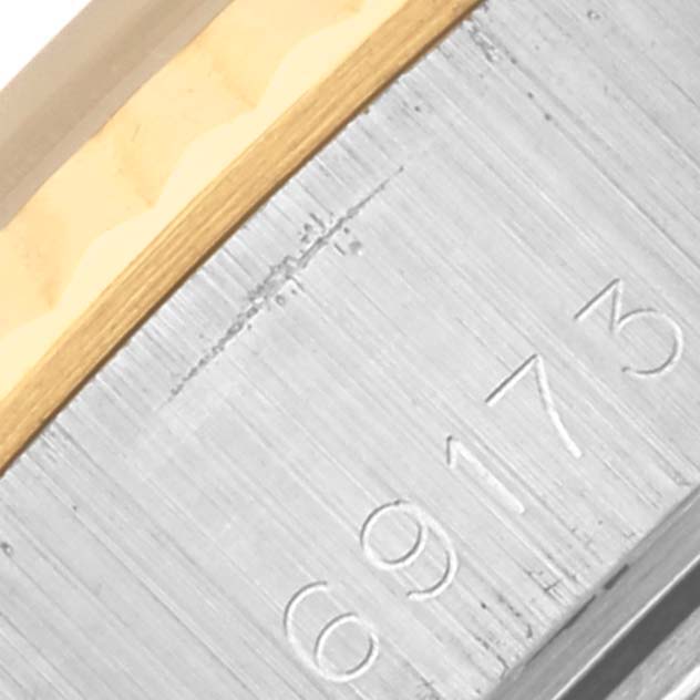 The image shows a close-up of the side of a Rolex Datejust 69173 Women's Steel and Gold (two tone) Black Dial 69173 Women's Steel and Gold (two tone) Black Dial model, focusing on the serial number engraving.