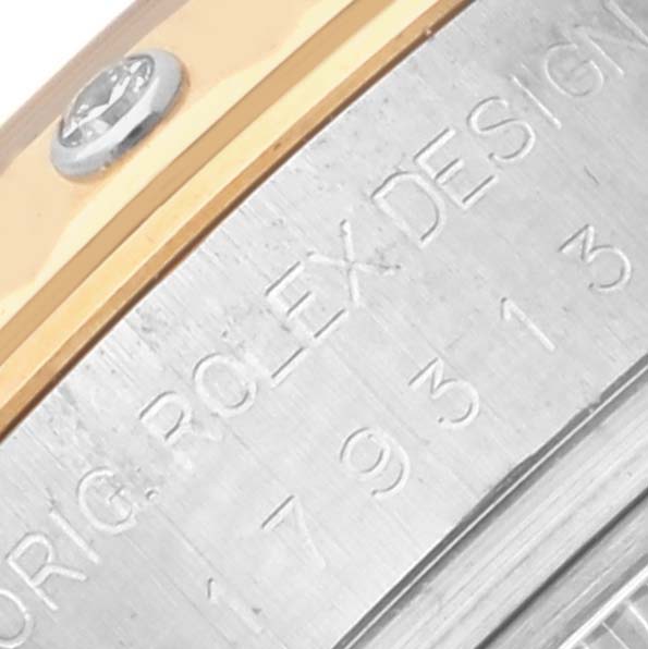 The image shows a close-up of the side of a Rolex Datejust 179313 Women's Steel and Gold (two tone) White Dial 179313 Women's Steel and Gold (two tone) White Dial, highlighting the engraved model number and design details.
