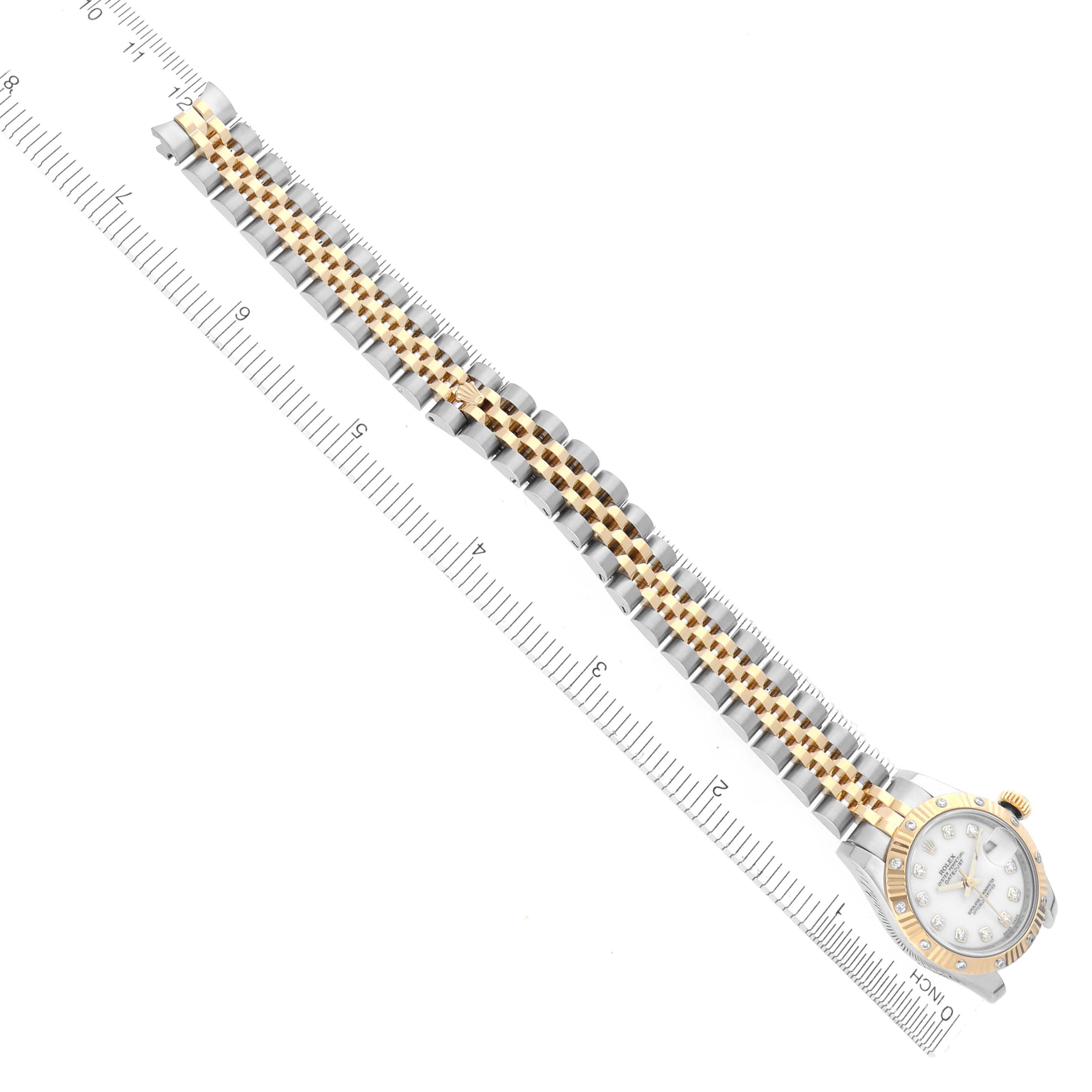 The Rolex Datejust 179313 Women's Steel and Gold (two tone) White Dial 179313 Women's Steel and Gold (two tone) White Dial watch is shown diagonally from the top, featuring its face, bezel, and two-tone bracelet alongside a ruler.
