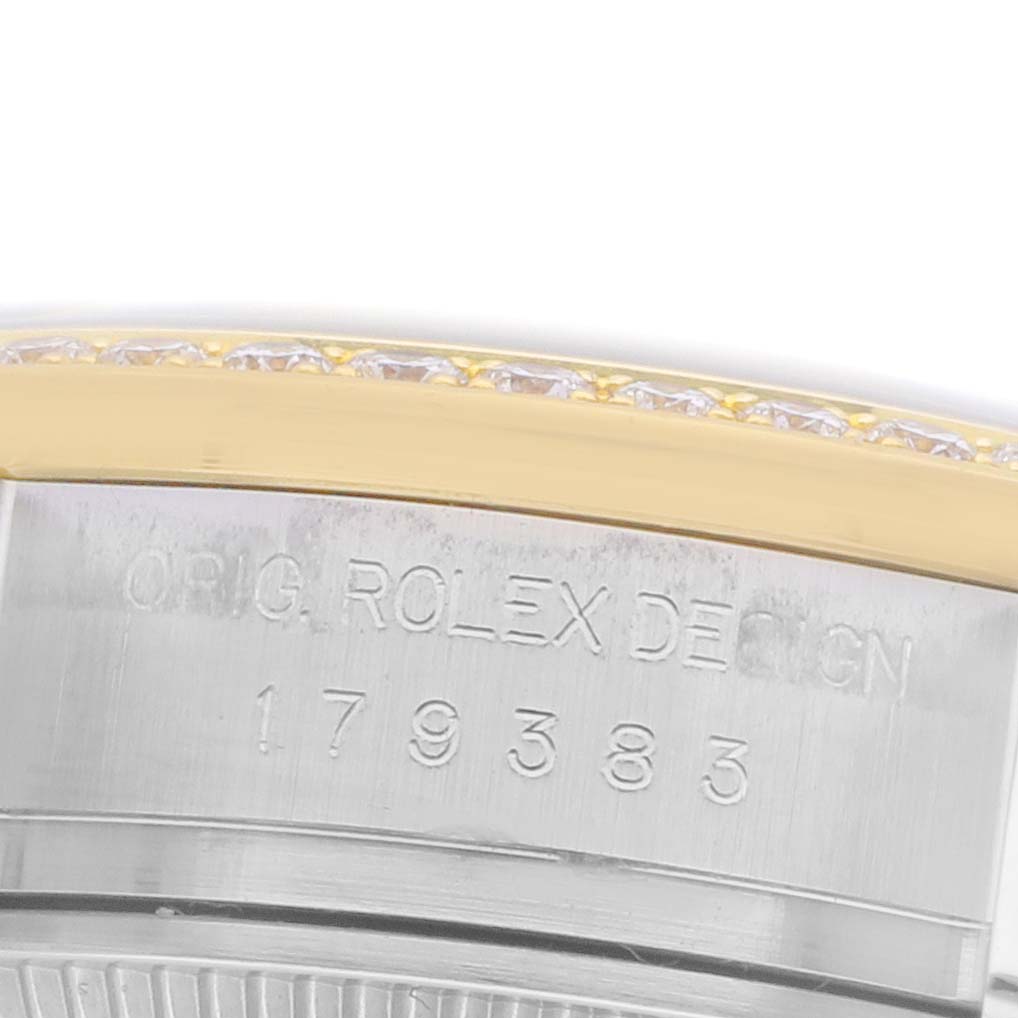 The image shows an angled close-up of a Rolex Datejust 179383 Women's Steel and Gold (two tone) White Dial 179383 Women's Steel and Gold (two tone) White Dial, focusing on the bezel and engraved serial number.