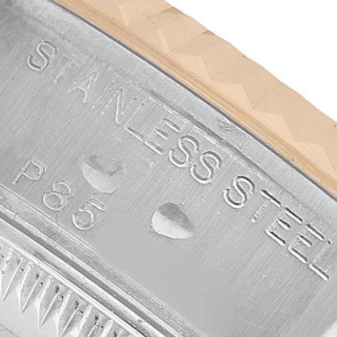 The image shows a close-up of the stainless steel side of the Rolex Datejust 79173 Women's Stainless Steel White Dial watch, highlighting engravings.