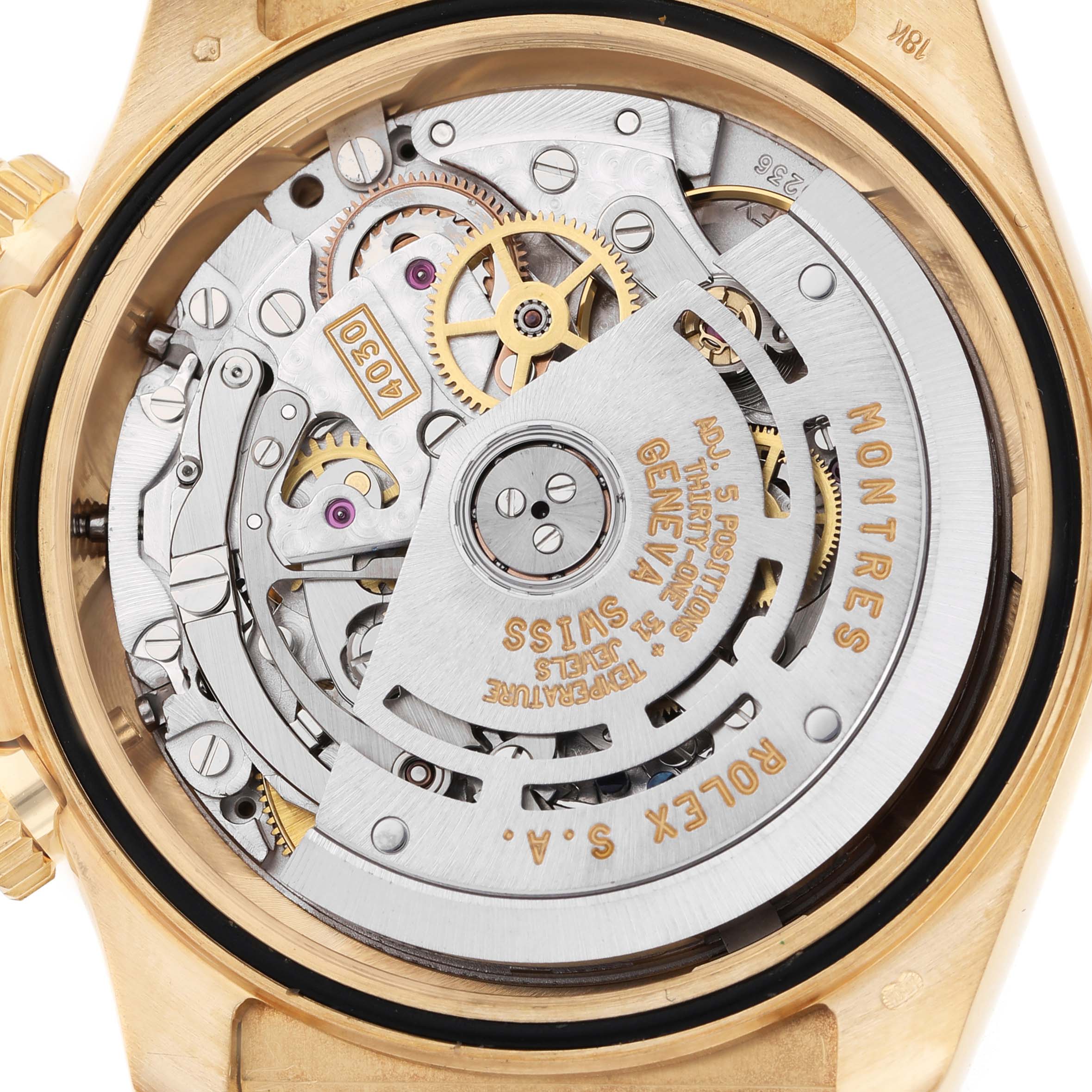 The image shows the back view of the Rolex Daytona 16518 Men's Yellow Gold White Dial, focusing on the intricate movement and gears inside.