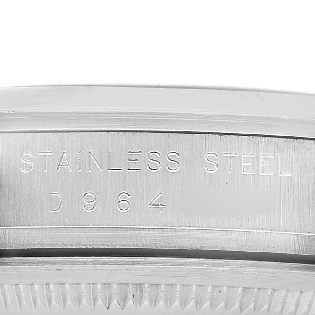 The image shows the side engraving on the case of a Rolex Explorer 114270 Men's Stainless Steel Black Dial watch, highlighting "STAINLESS STEEL" and partial serial number.