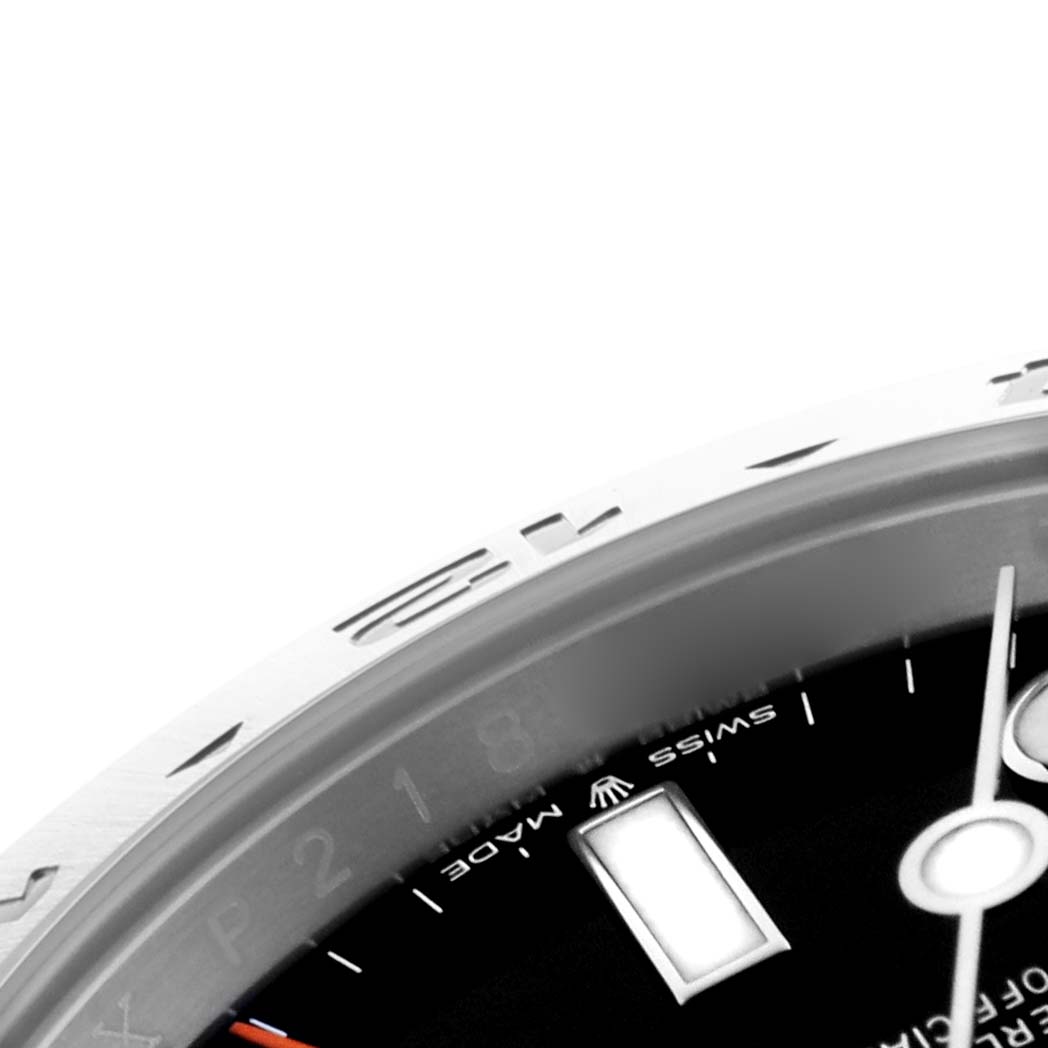 The image shows a partial view of the Rolex Explorer 226570 Men
s Stainless Steel Black Dial 226570 Men
s Stainless Steel Black Dial watch, focusing on the bezel, part of the dial, and hands from a close angle.