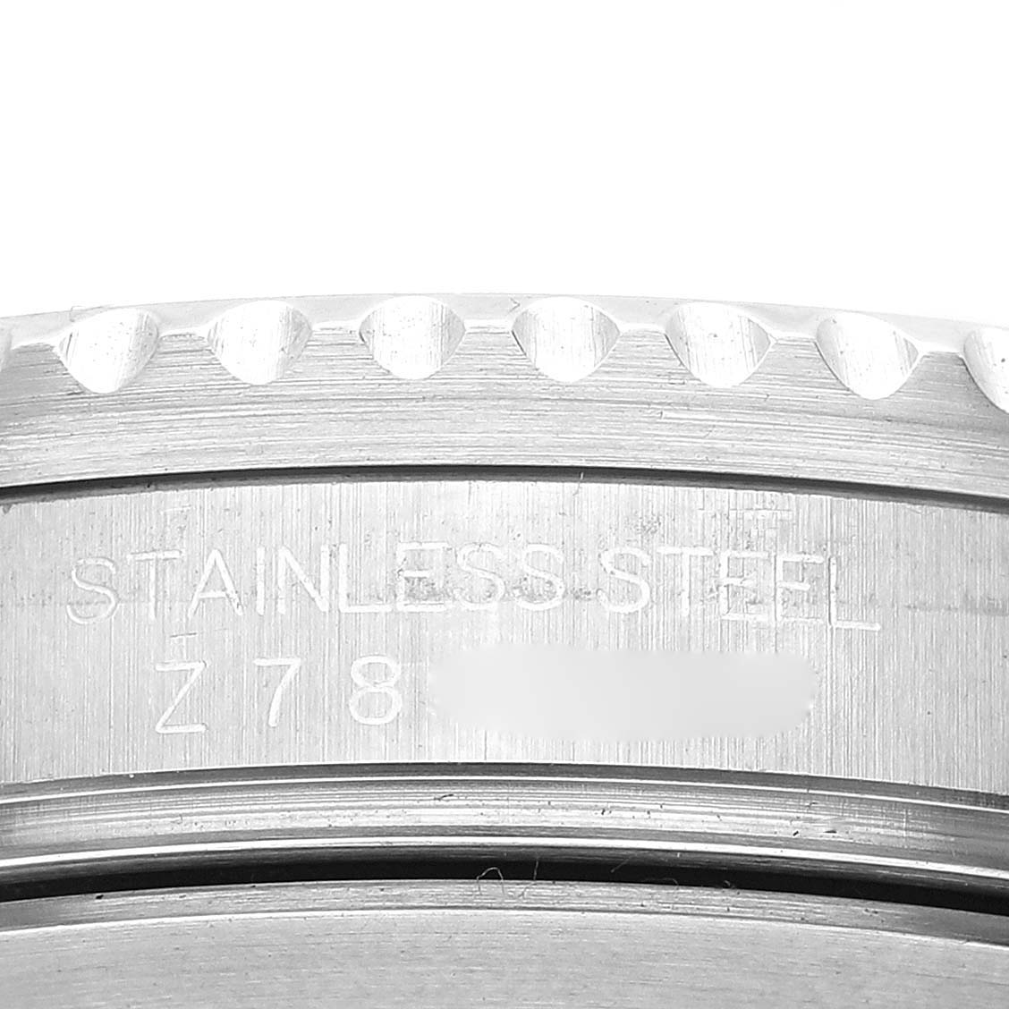 This image shows a close-up of the stainless steel case back edge of a Rolex GMT-Master 16710 Men's Stainless Steel Black Dial 16710 Men's Stainless Steel Black Dial.