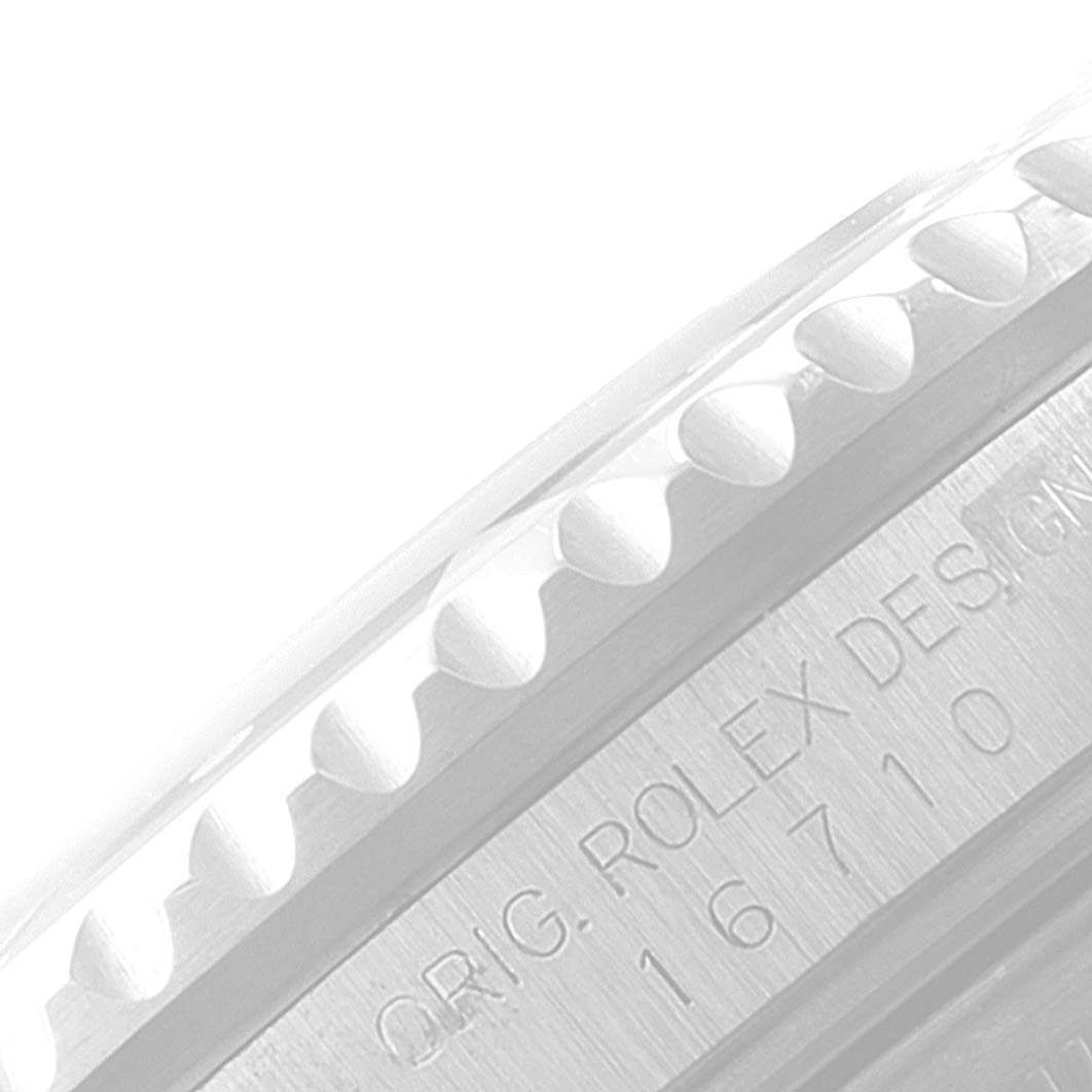 The image shows a close-up of the side of the bezel and part of the engraving on the case of the Rolex GMT-Master 16710 Men
s Stainless Steel Black Dial 16710 Men
s Stainless Steel Black Dial.