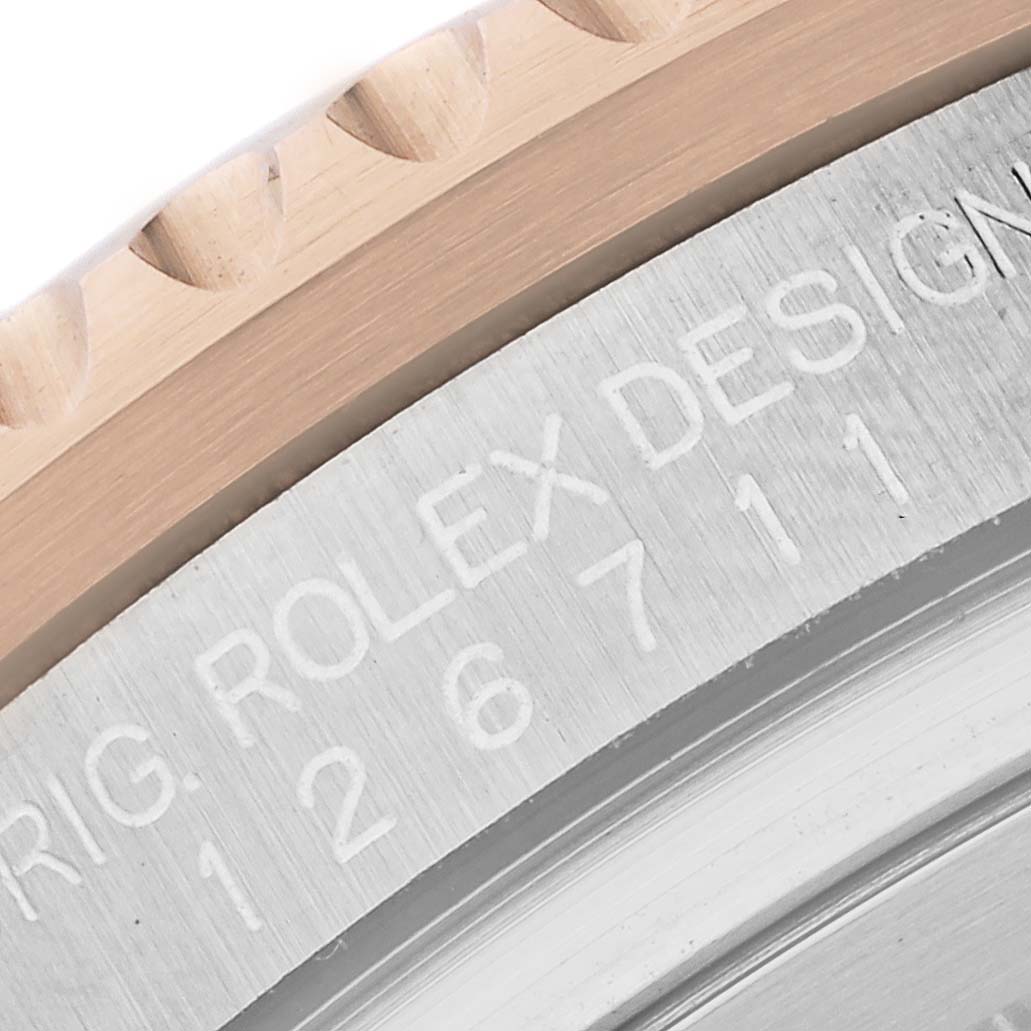 Close-up of the engraved bezel and case of a Rolex GMT-Master 126711CHNR Men's Steel and Gold (two tone) Black Dial 126711CHNR Men's Steel and Gold (two tone) Black Dial watch, showing the model number and part of the brand name.