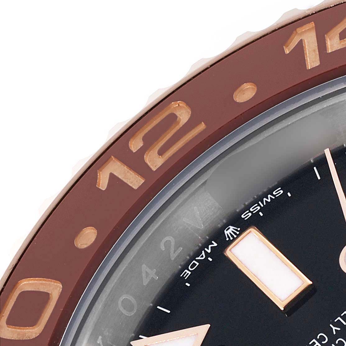 The image shows a close-up of the bezel and part of the dial of a Rolex GMT-Master 126711CHNR Men's Steel and Gold (two tone) Black Dial 126711CHNR Men's Steel and Gold (two tone) Black Dial watch, focusing on the 12 and 14 hour markers.