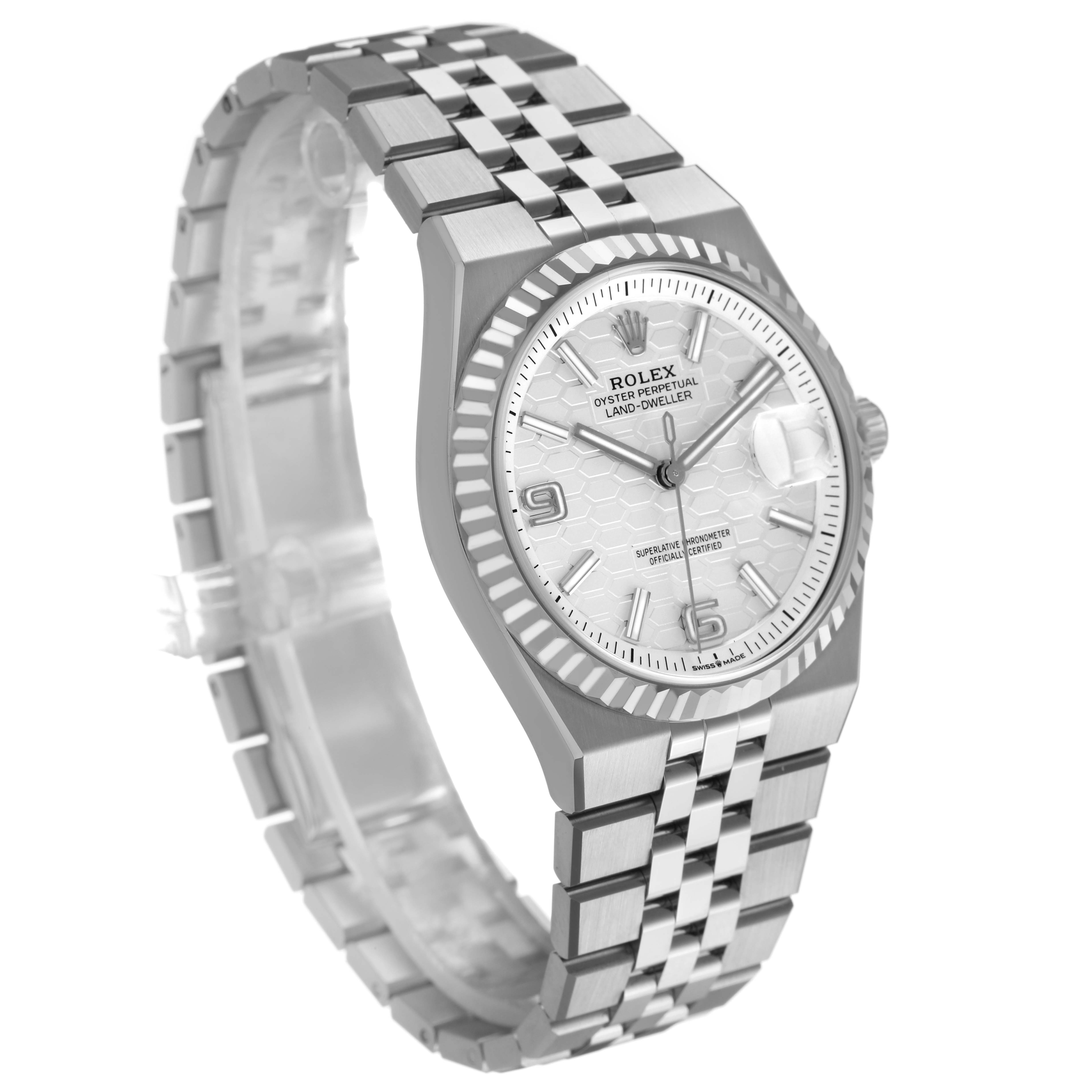 The Rolex Land-Dweller watch is shown at an angled front view, highlighting the dial, bezel, and jubilee bracelet.