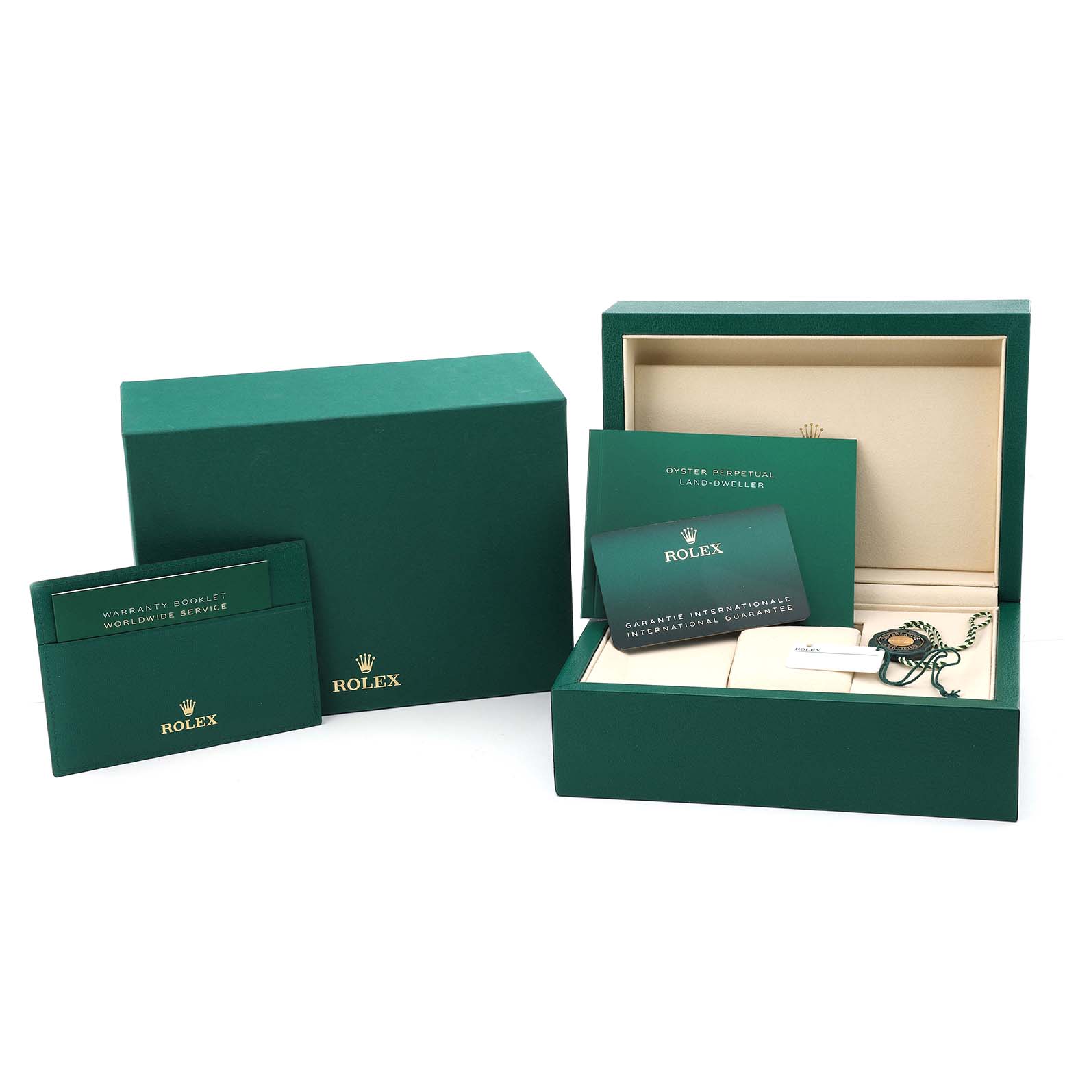 The image shows a Rolex Land-Dweller watch box set with warranty booklet and international guarantee card.
