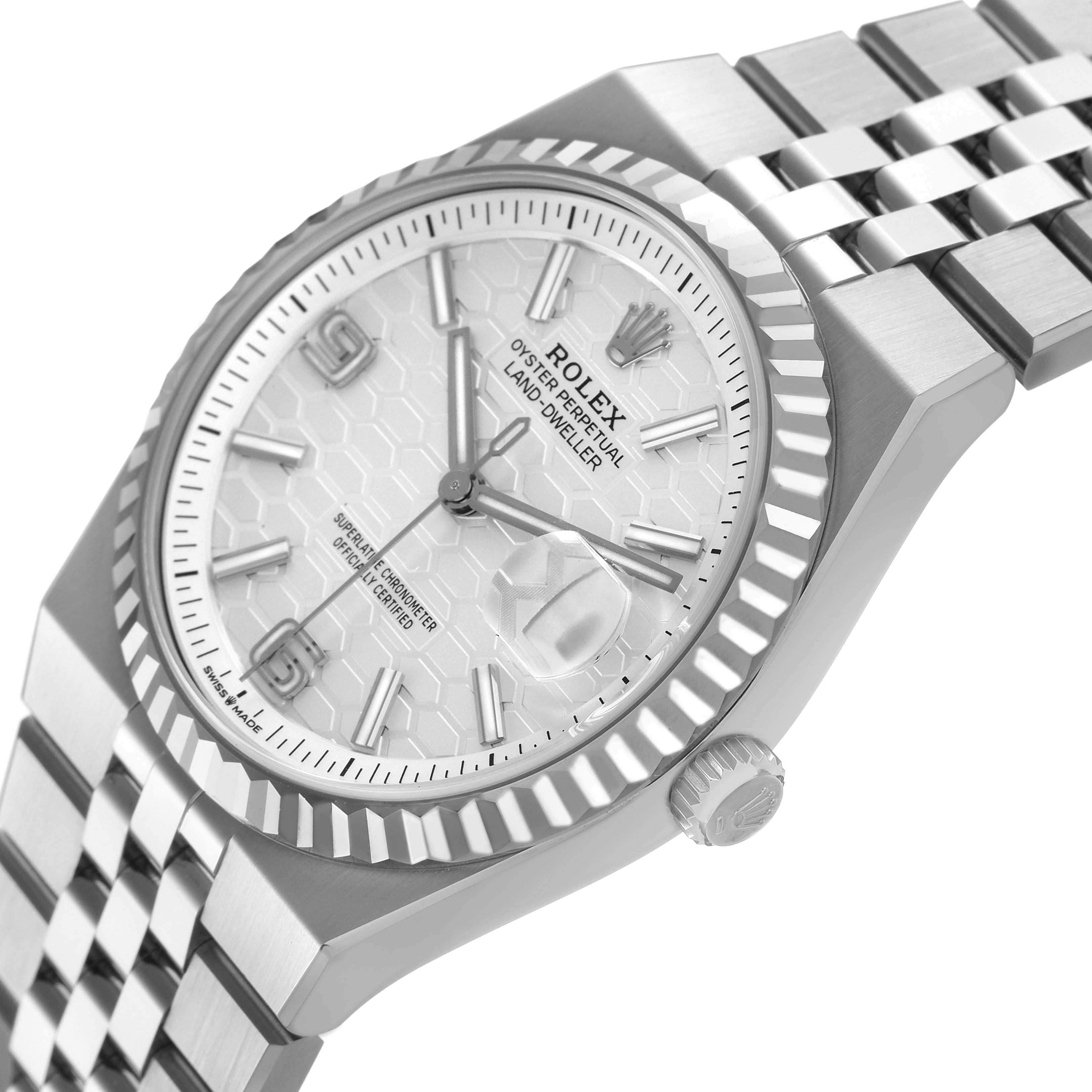 The Rolex Land-Dweller watch is shown at an oblique angle, highlighting the face, bezel, and part of the bracelet.