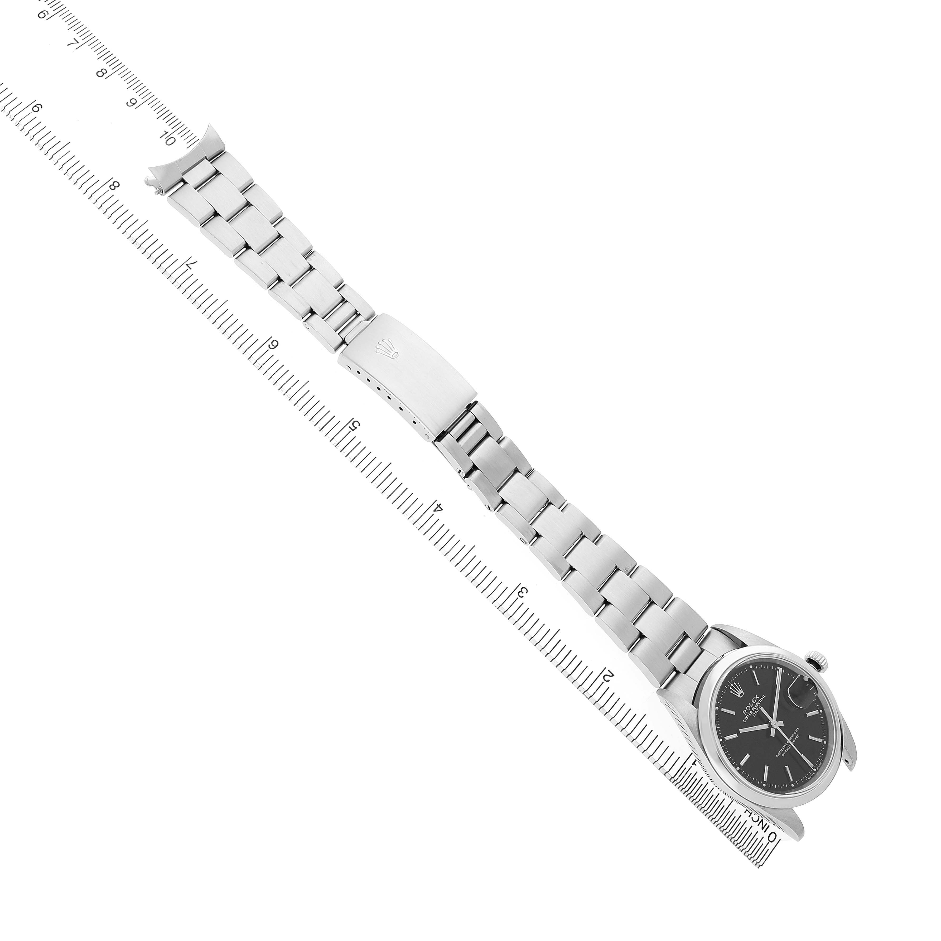 The image shows a top-down angle of a Rolex Date 15200 Men's Stainless Steel Black Dial model watch, highlighting the face, bracelet, and clasp.