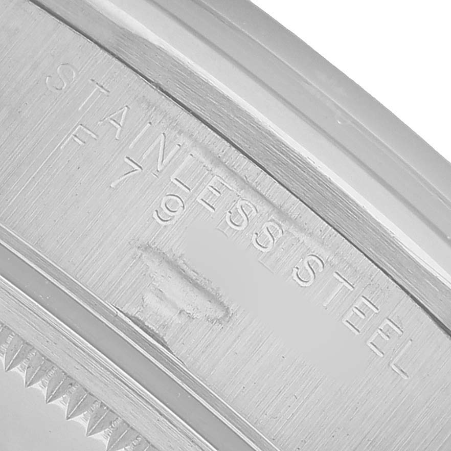 The image shows a close-up of the stainless steel inner rim of a Rolex Date 15200 Men's Stainless Steel Black Dial model.