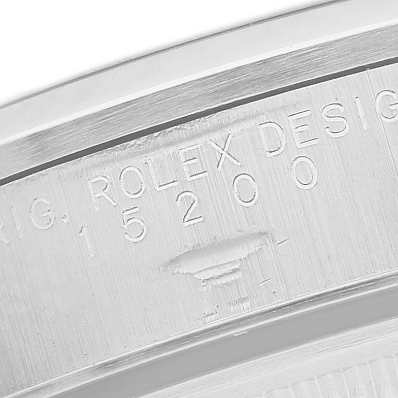 The image displays the engraved side of a Rolex Oyster Perpetual 15200 Men's Stainless Steel Black Dial, showing model details.