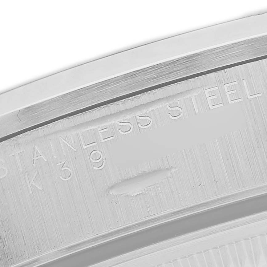 The image shows a close-up of the case back edge on a Rolex Oyster Perpetual 15200 Men's Stainless Steel Black Dial, highlighting engraved text.