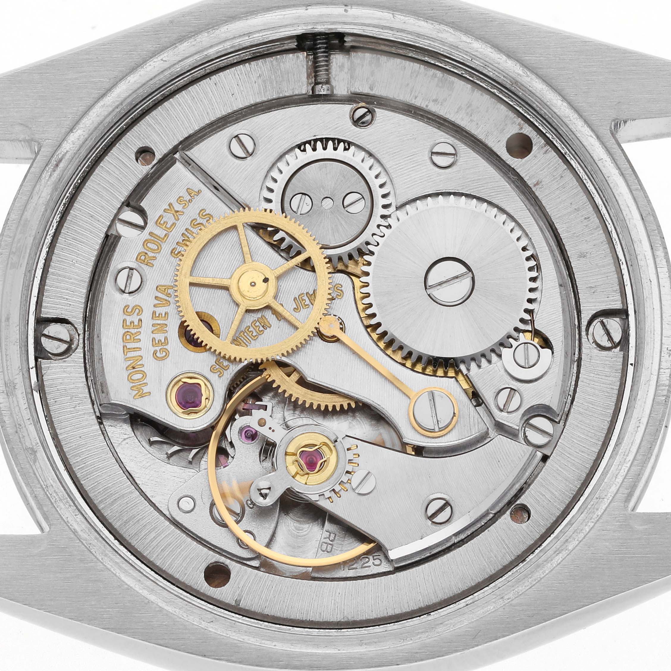 The image shows the movement of a Rolex Date 6694 Men's Stainless Steel Silver Dial 6694 Men's Stainless Steel Silver Dial watch from a top-down angle displaying gears, jewels, and mechanisms.