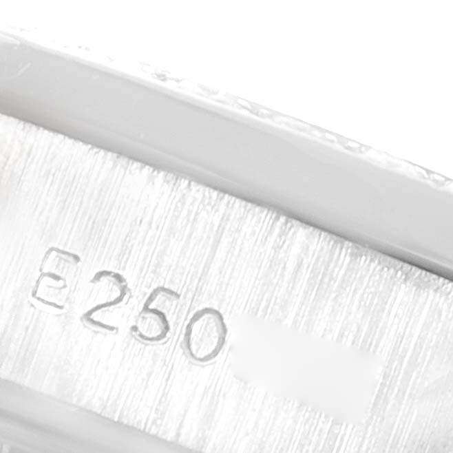 This close-up image shows a partial view of the engraved serial number inside the case of a Rolex President 69136 Women's Platinum Silver Dial 69136 Women's Platinum Silver Dial model watch.