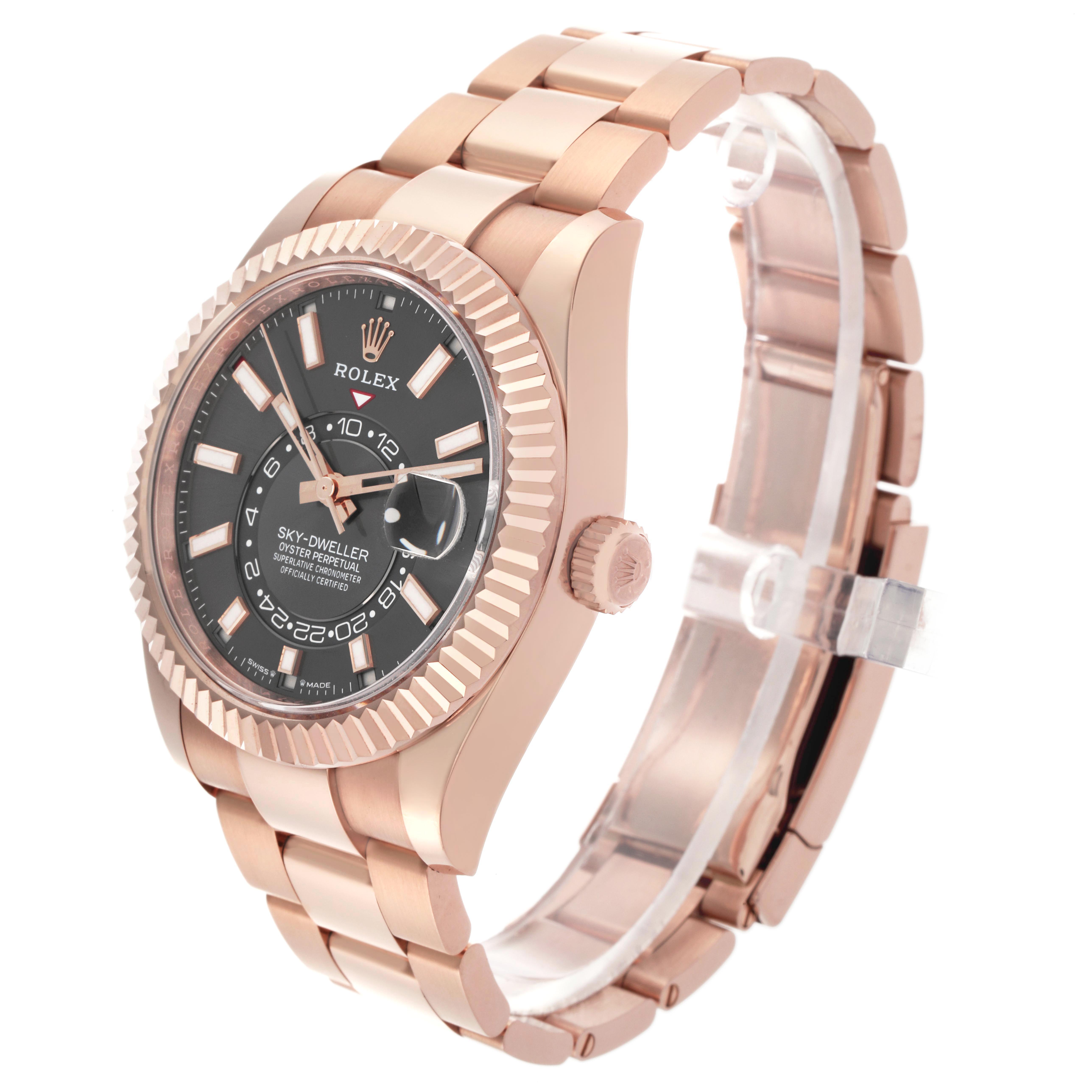 The Rolex Sky-Dweller 336935 Men's Rose Gold Grey Dial is shown at a three-quarter angle, highlighting its rose gold case, bezel, black dial, and bracelet.