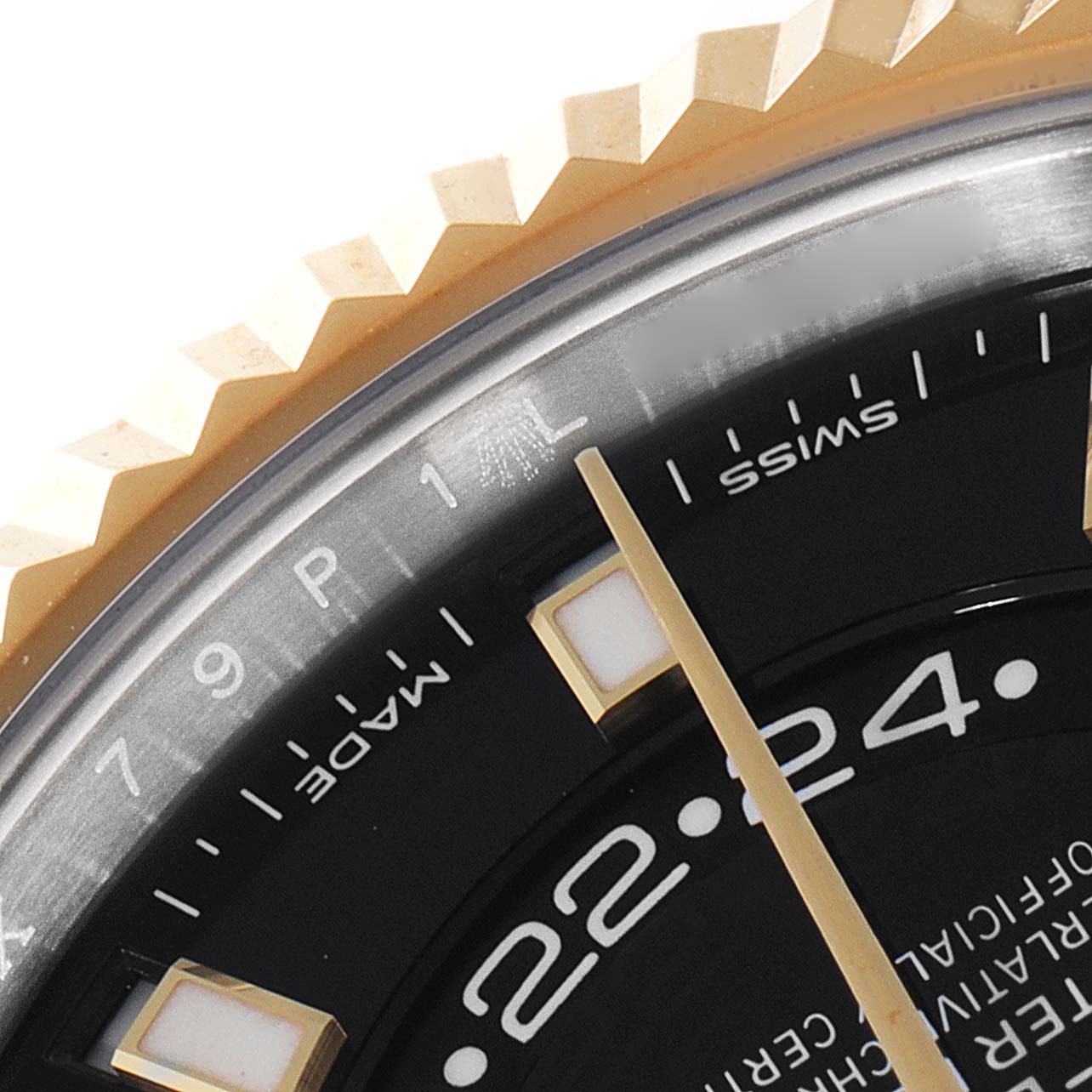 This close-up shows the bezel, part of the dial, and the minute hand of the Rolex Sky-Dweller 326933 Men's Steel and Gold (two tone) Black Dial 326933 Men's Steel and Gold (two tone) Black Dial watch.