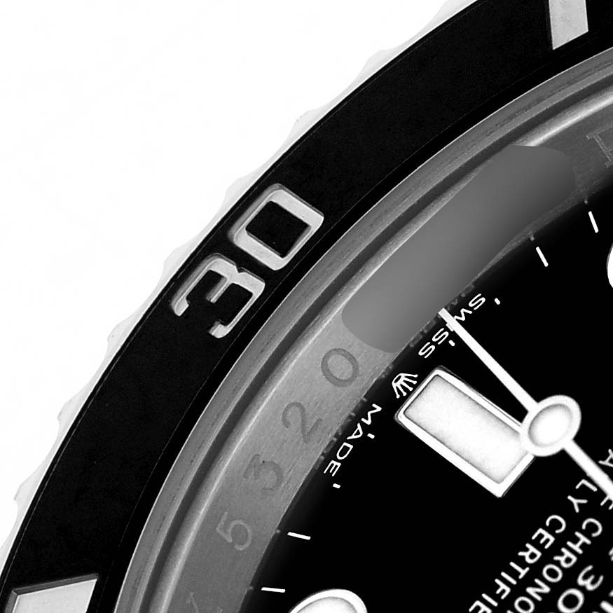 The image shows a close-up angle of the bezel and part of the dial of a Rolex Submariner 124060 Men's Stainless Steel Black Dial watch.