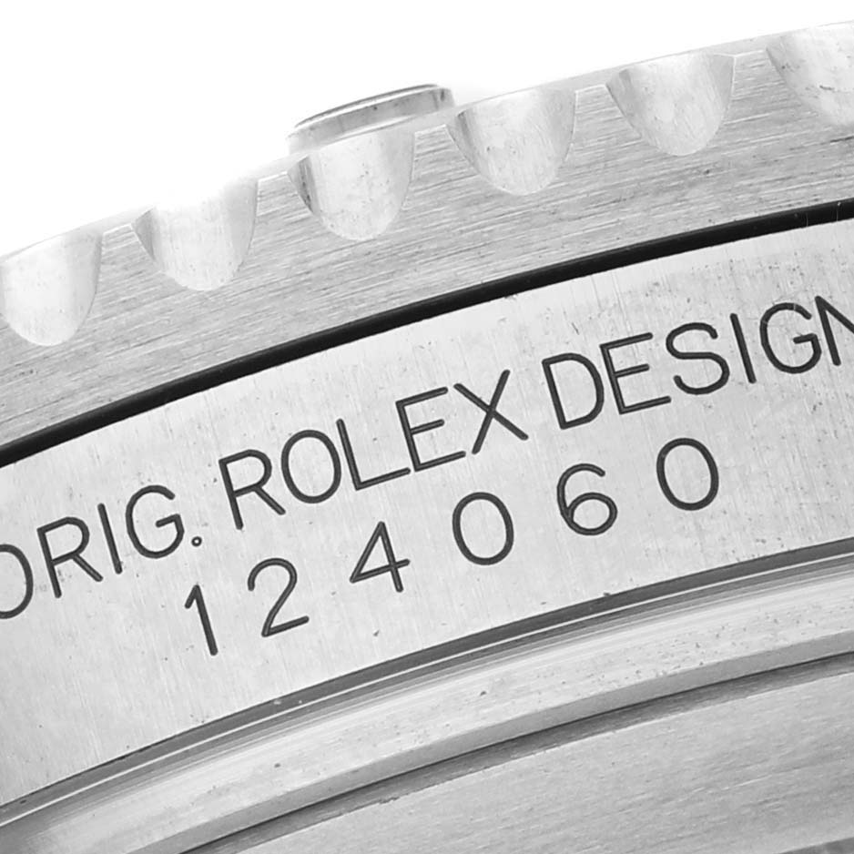 The image shows a close-up of the Rolex Submariner 124060 Men's Stainless Steel Black Dial's case side, featuring model and design engravings.