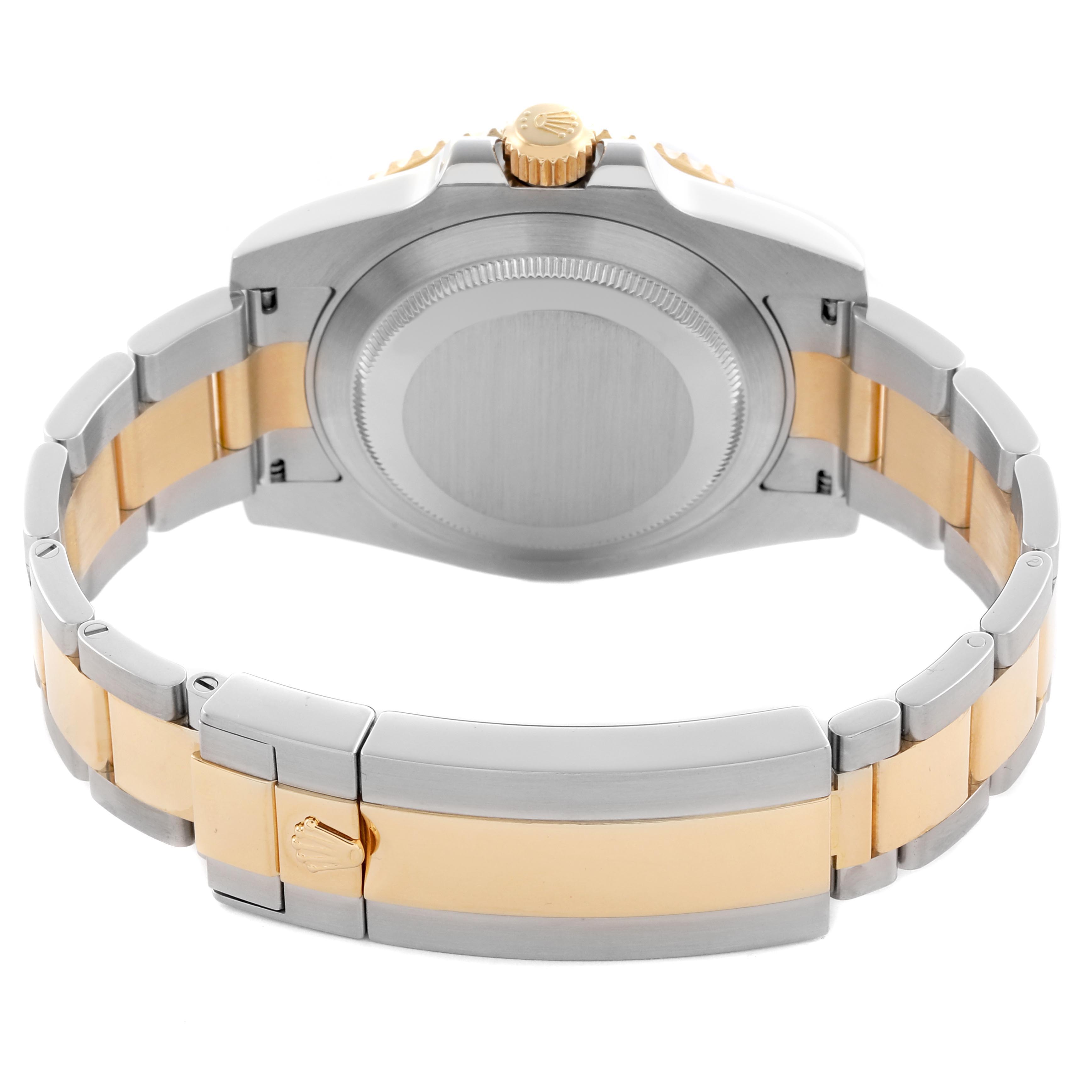 The image shows the back and bracelet clasp of a Rolex Submariner 116613 Men's Steel and Gold (two tone) Black Dial 116613 Men's Steel and Gold (two tone) Black Dial watch, highlighting its two-tone design and crown motif.