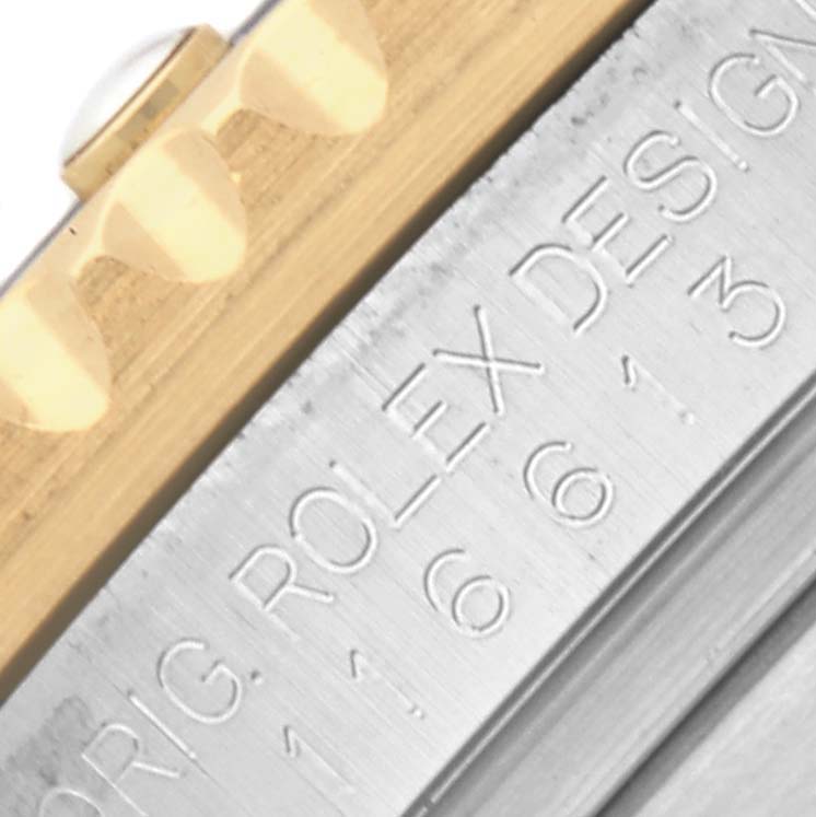 The image shows a close-up of the Rolex Submariner 116613LB Men's Steel and Gold (two tone) Blue Dial 116613LB Men's Steel and Gold (two tone) Blue Dial's engraved outer edge and gold bezel.