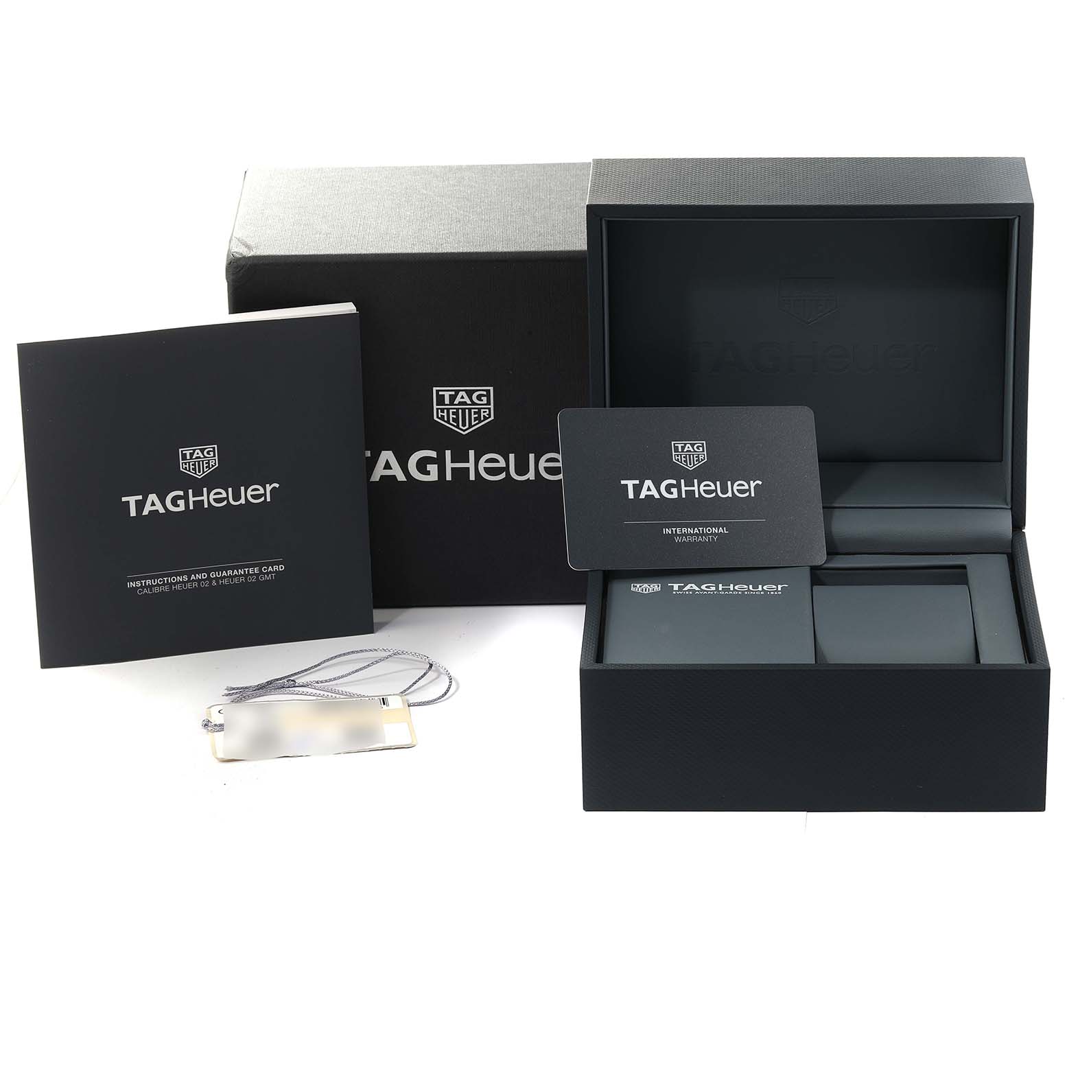 This image shows the packaging, warranty cards, and instruction manual for a Tag Heuer Carrera CBN2A10.BA0643 Men's Stainless Steel Green Dial CBN2A10.BA0643 Men's Stainless Steel Green Dial watch.