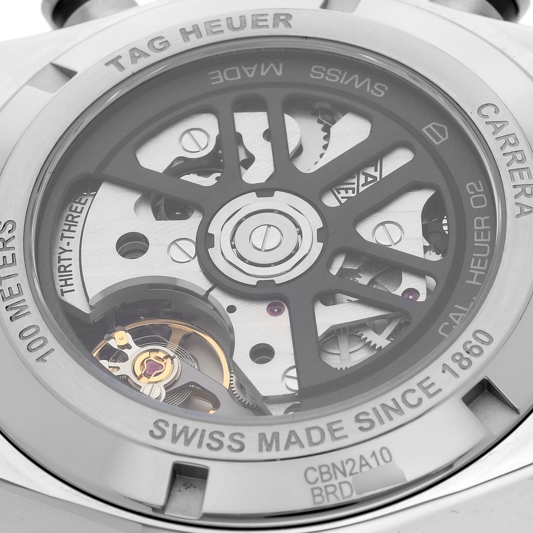 The image shows the back view of the Tag Heuer Carrera CBN2A10.BA0643 Men's Stainless Steel Green Dial CBN2A10.BA0643 Men's Stainless Steel Green Dial watch, highlighting its intricate movement and engravings.