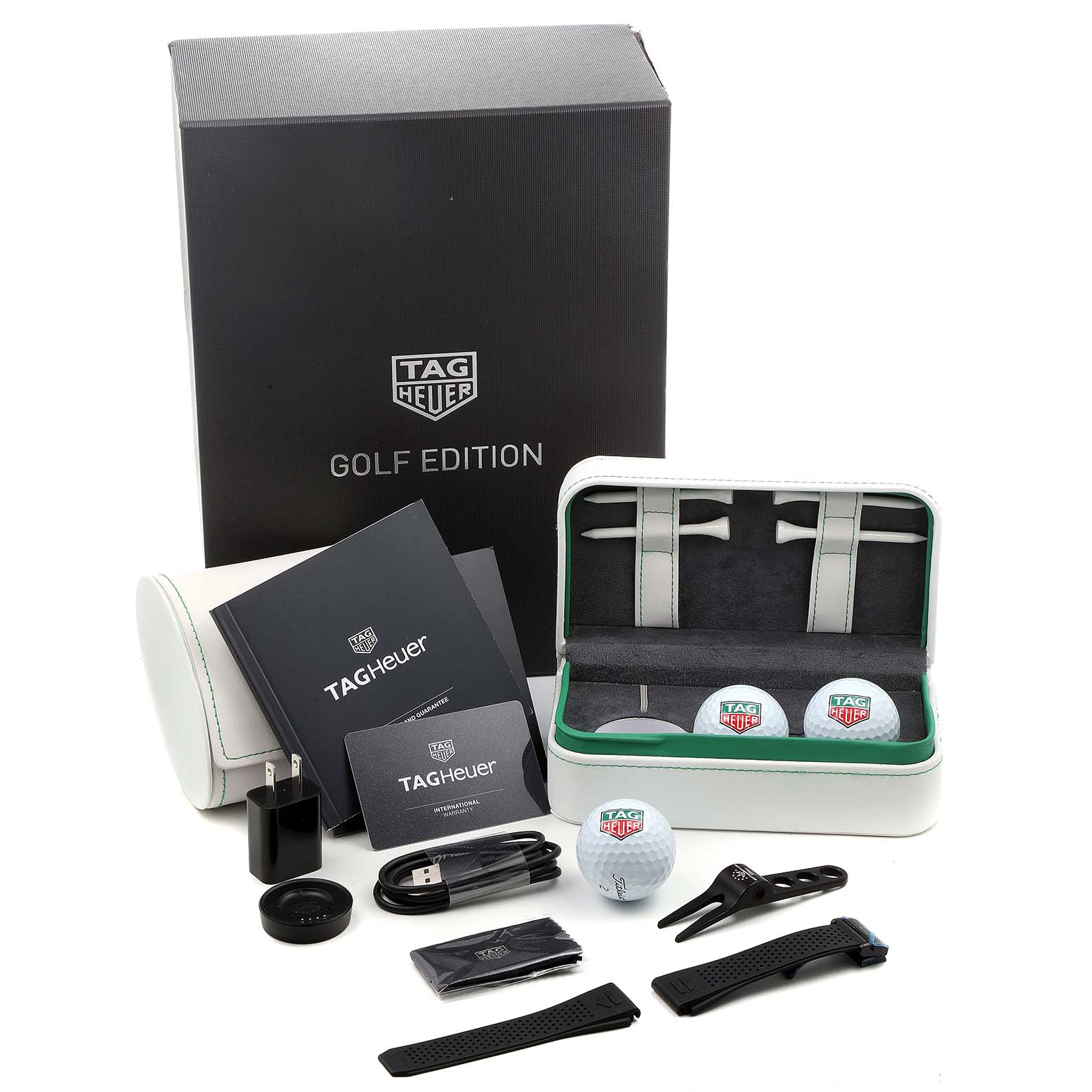 The image shows a Tag Heuer Connected SBG8A82.EB0206 Men's Titanium  SBG8A82.EB0206 Men's Titanium  Golf Edition watch set with accessories, from a top-down angle.