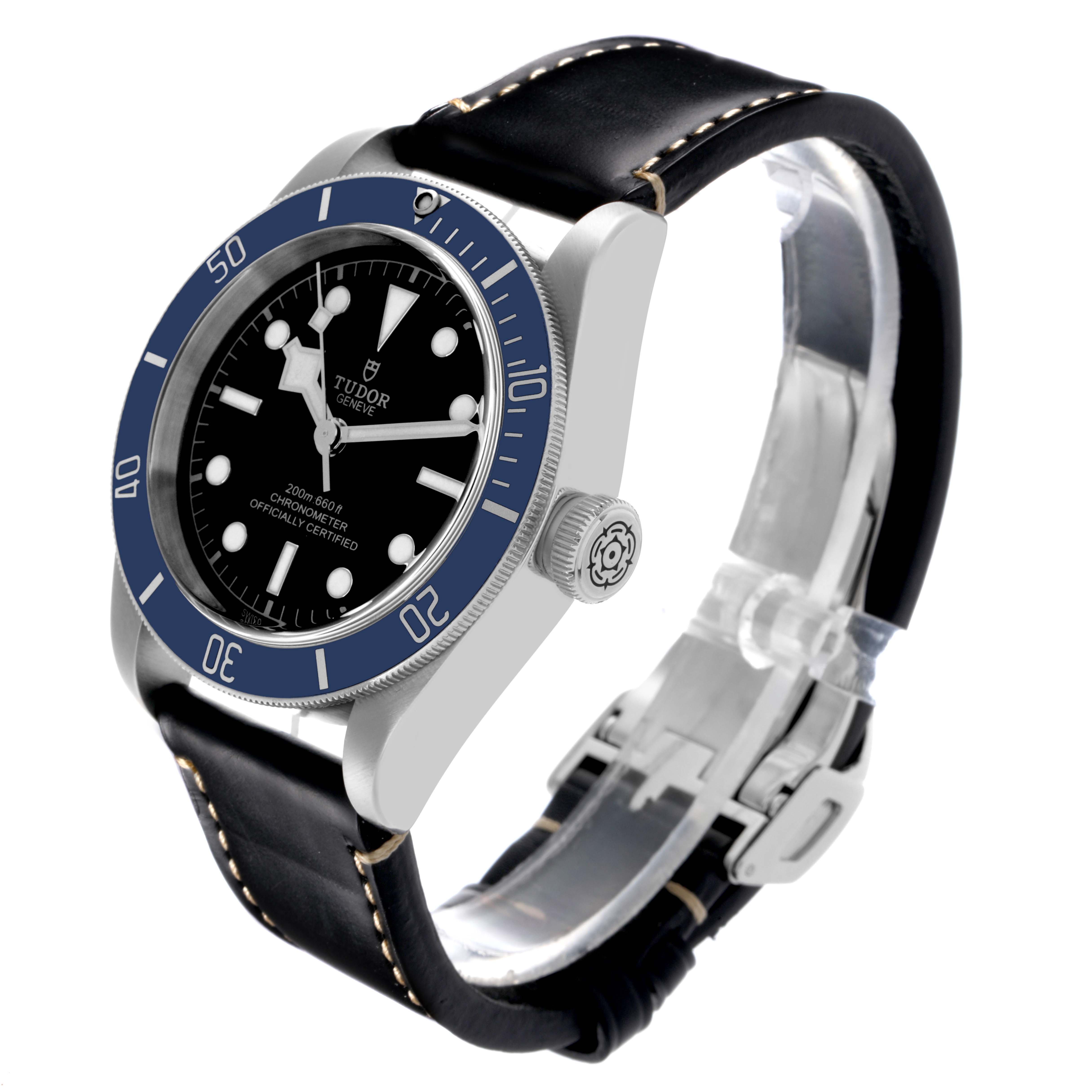The Tudor Heritage Black Bay 79230B Men's Stainless Steel Black Dial 79230B Men's Stainless Steel Black Dial watch is shown at a three-quarter angle, highlighting the face, bezel, crown, and leather strap.
