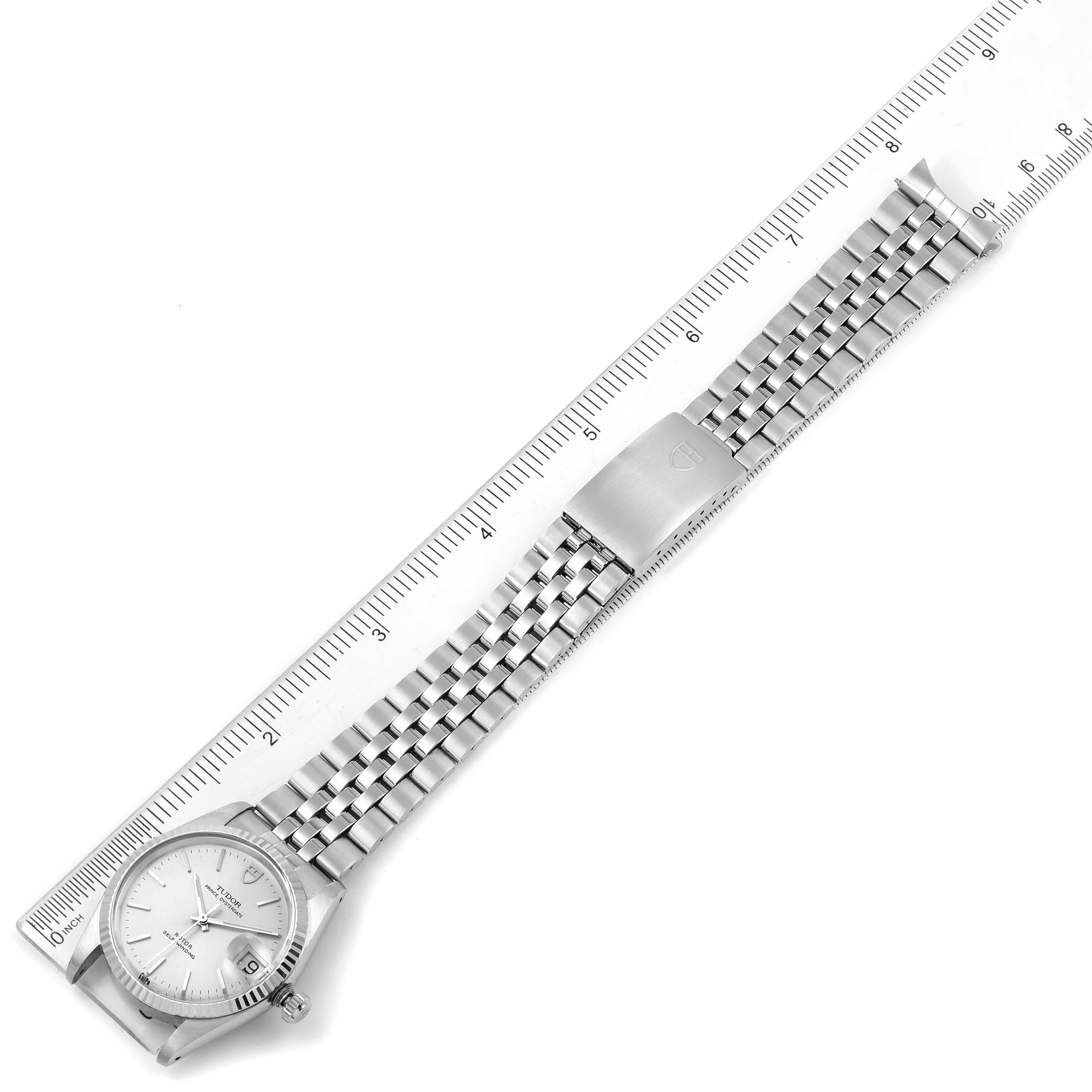 The Tudor Prince 74034 Men's Stainless Steel Silver Dial 74034 Men's Stainless Steel Silver Dial watch is shown from a top-down angle, displaying its face and full metal bracelet next to a ruler for scale.