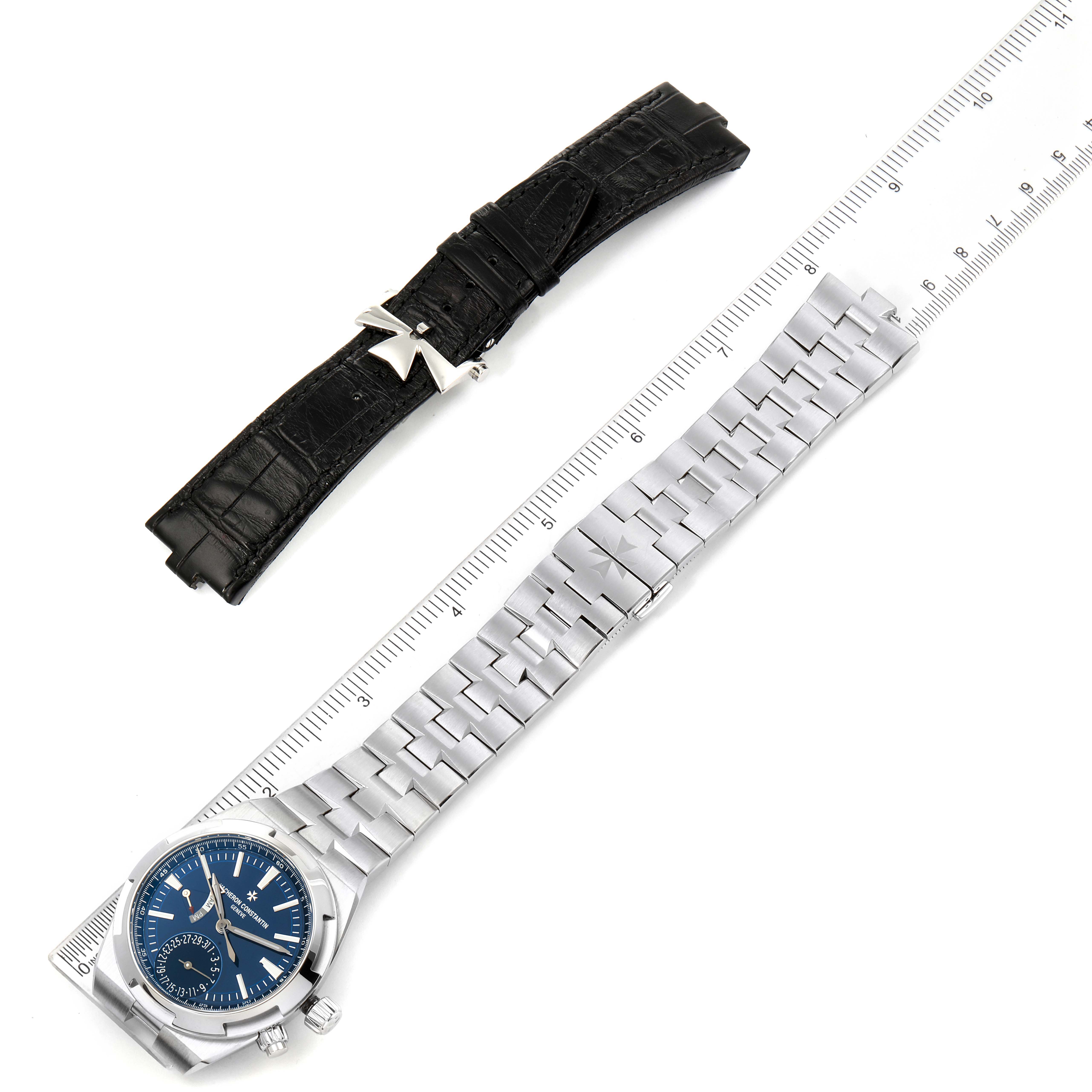 The image shows a Vacheron Constantin Overseas 7900V/110A-B334 Men's Stainless Steel Blue Dial 7900V/110A-B334 Men's Stainless Steel Blue Dial watch with a blue dial, alongside a black leather strap and a ruler for scale.